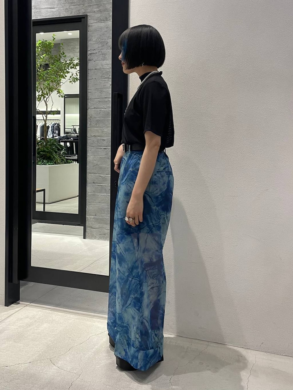 ホワイト系のサンダル、ブルー系のその他パンツ、ブラック系のTシャツ/カットソーを着用したレディースの春コーディネートの3枚目の写真