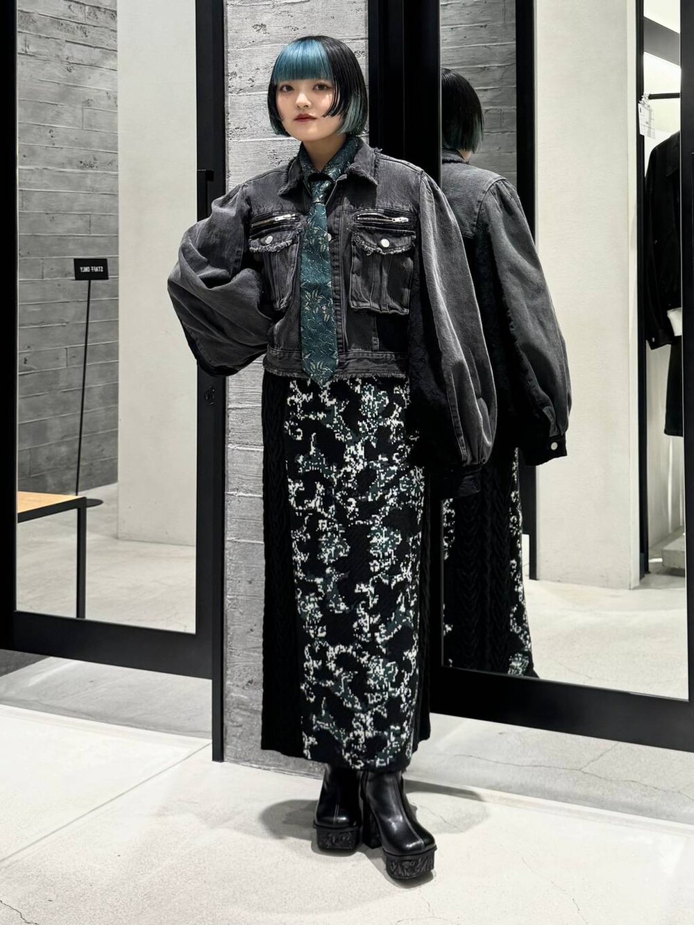 ブラック系のスカート、グリーン系のシャツ/ブラウス、グレー系のブーツを着用したレディースの秋コーディネートの5枚目の写真