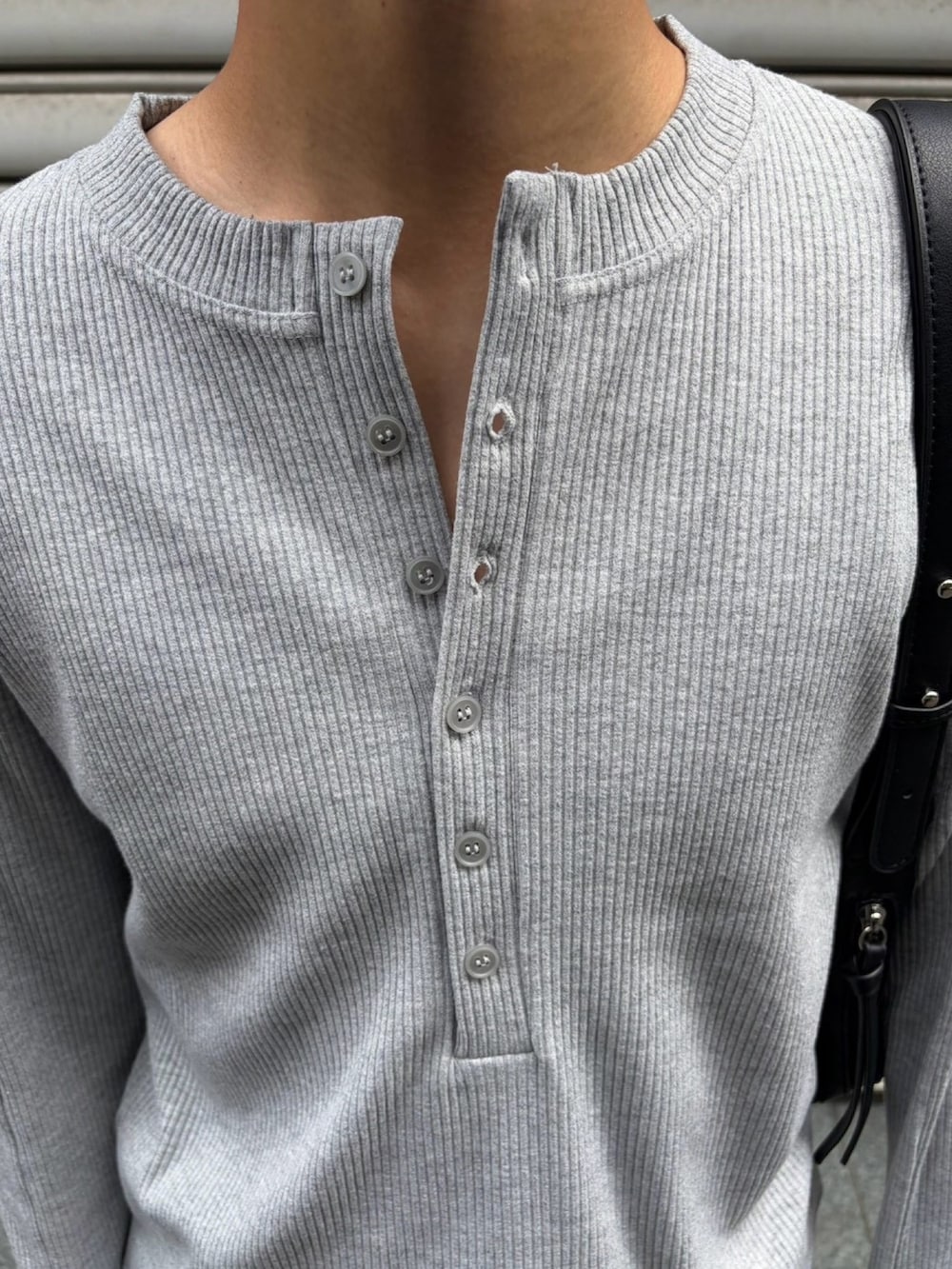 グレー系のTシャツ/カットソー、ブラック系のショルダーバッグ、ブルー系のデニムパンツを着用したメンズの秋コーディネートの6枚目の写真