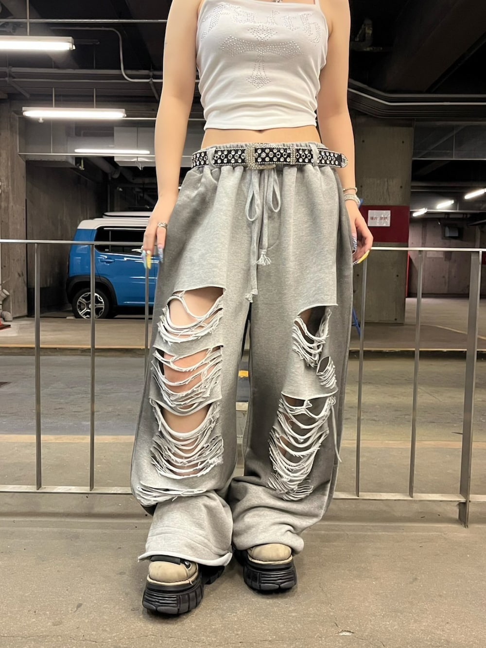 グレー系のスウェットパンツ、ホワイト系のキャミソール、シルバー系のネックレスを着用したレディースの夏コーディネートの4枚目の写真
