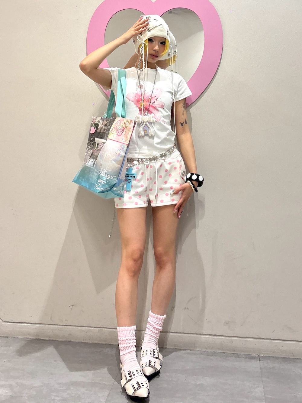 ブルー系のトートバッグ、ホワイト系のTシャツ/カットソー、ピンク系のスウェットパンツを着用したレディースの夏コーディネートの2枚目の写真