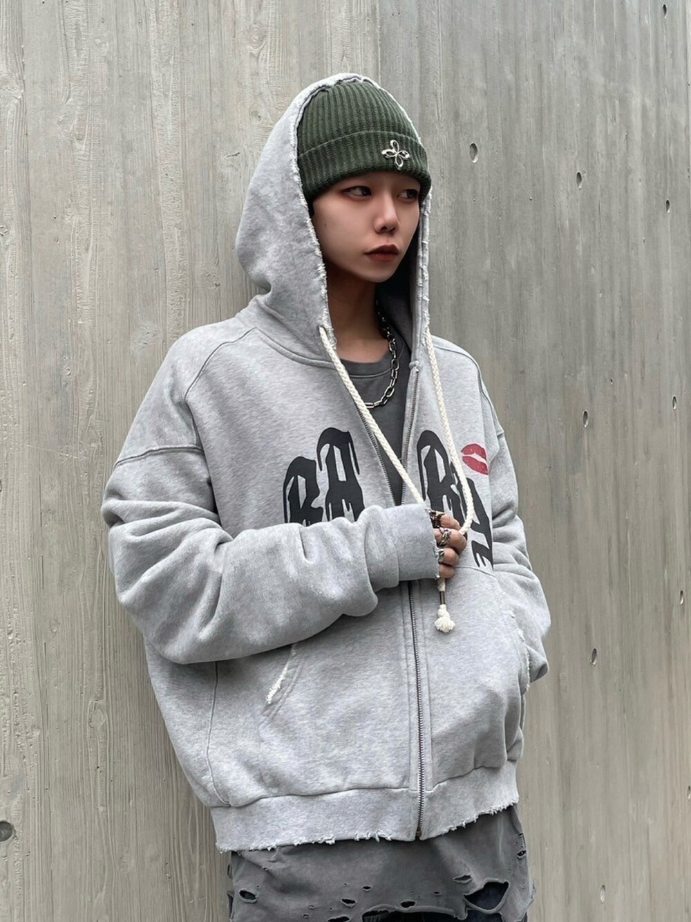 ブラック系のデニムジャケット、グレー系のパーカー、グリーン系のニットキャップ/ビーニーを着用したメンズの秋コーディネートの2枚目の写真