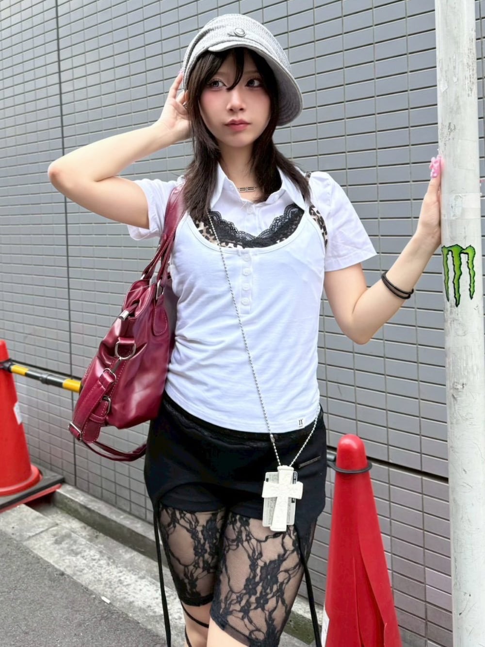レッド系のショルダーバッグ、グレー系のキャップを着用したレディースの夏コーディネートの3枚目の写真