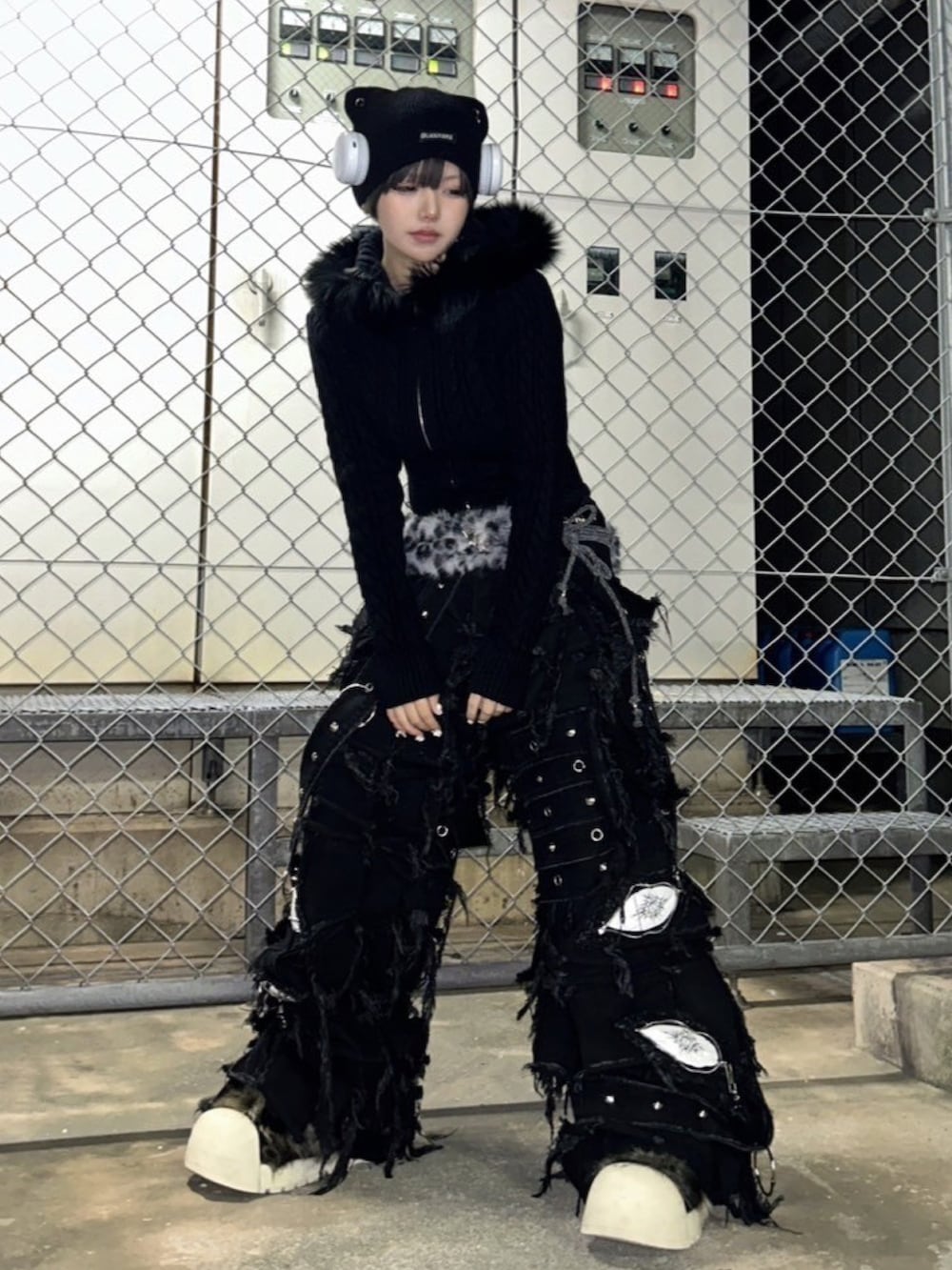 ブラック系のブーツ、ブラック系のデニムパンツ、ブラック系のニットキャップ/ビーニーを着用したレディースの冬コーディネートの2枚目の写真