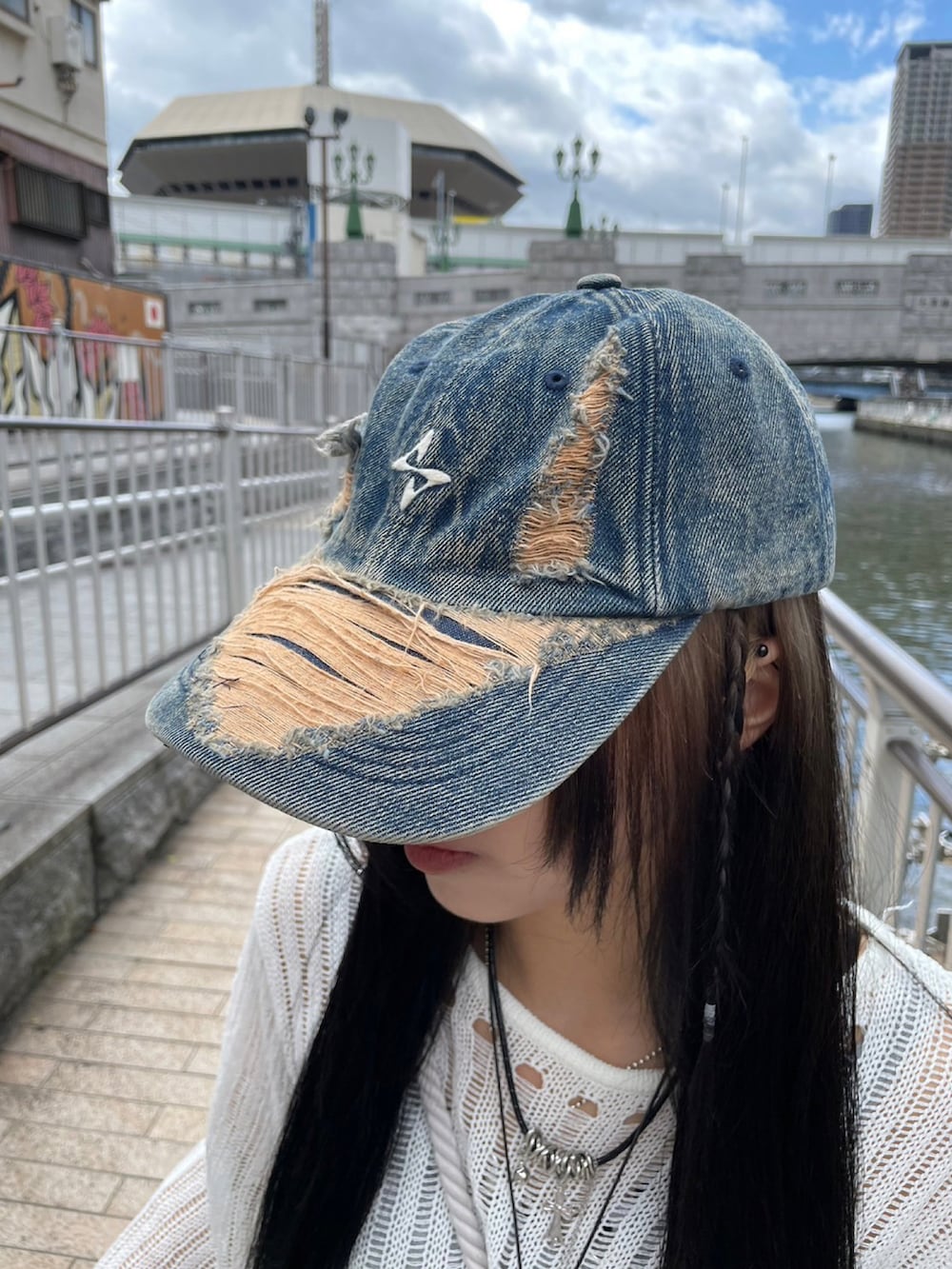 ブルー系のデニムパンツ、ブラック系のスニーカー、グレー系のバックパック/リュックを着用したレディースの春コーディネートの3枚目の写真