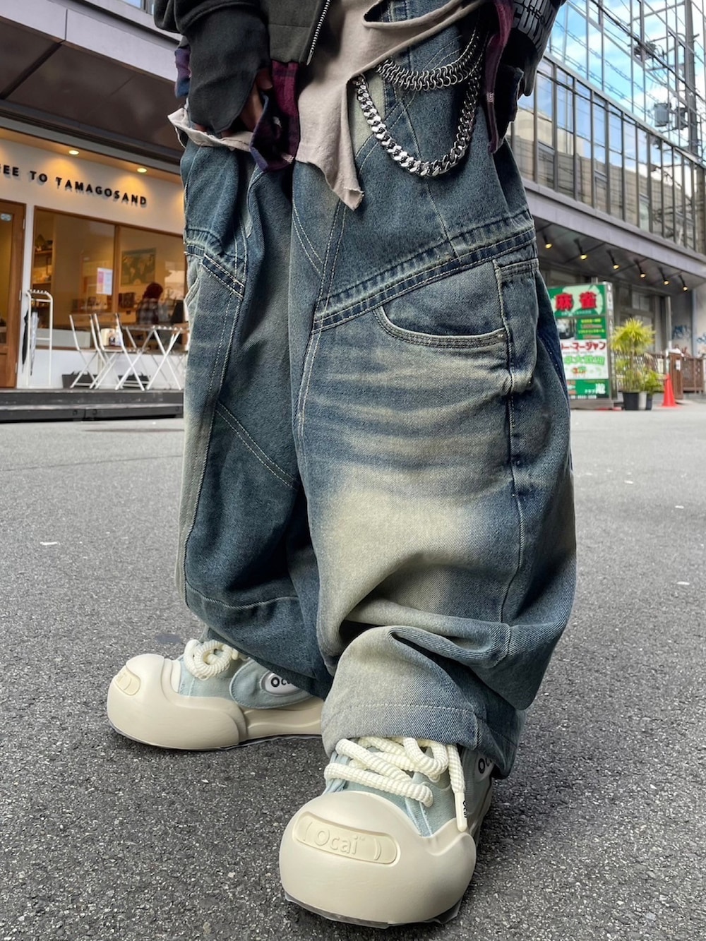 グリーン系のバックパック/リュック、グレー系のTシャツ/カットソー、ブルー系のデニムパンツを着用したレディースの冬コーディネートの3枚目の写真