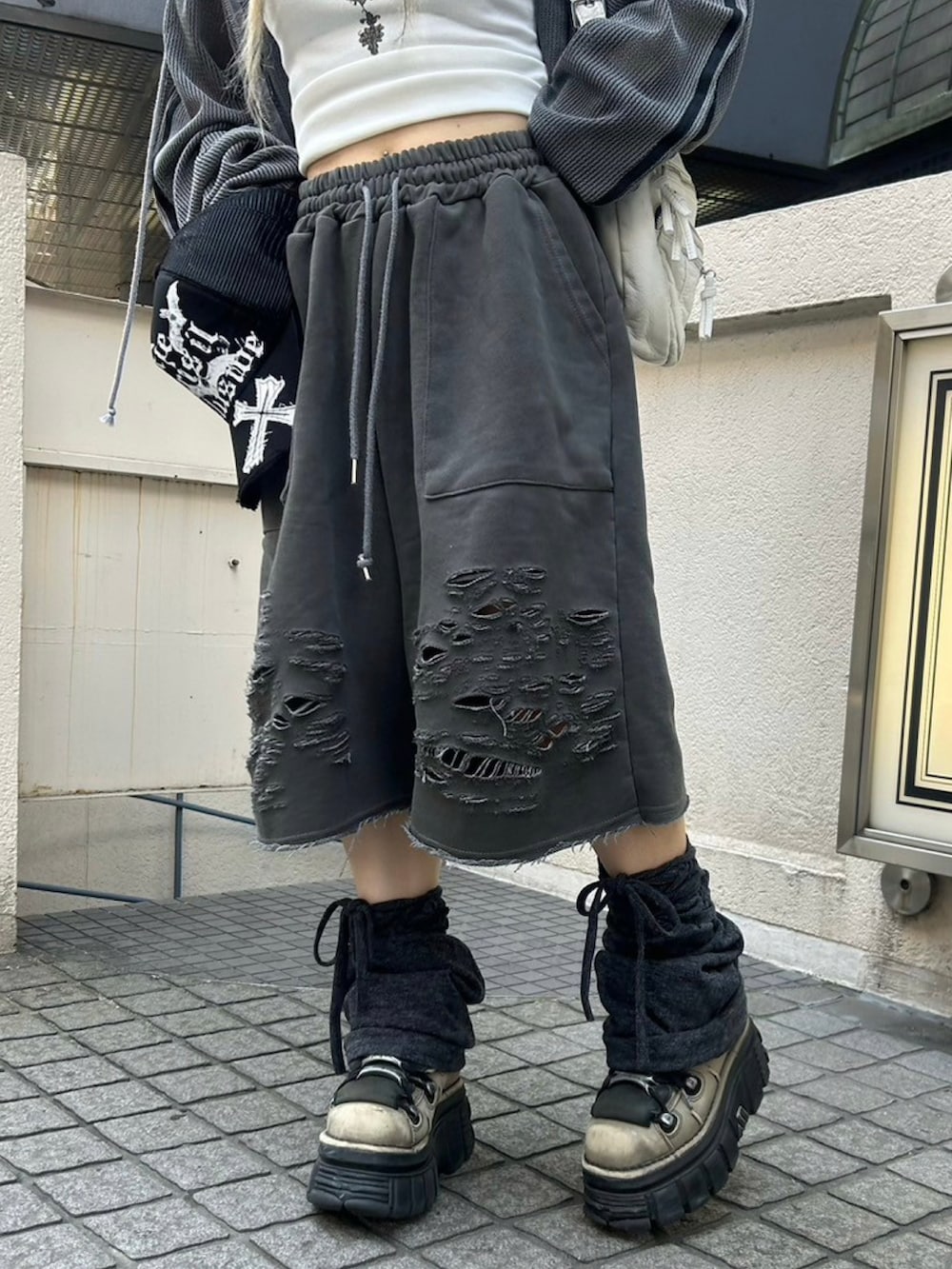 ホワイト系のタンクトップ、グレー系のパーカー、ホワイト系のショルダーバッグを着用したレディースの夏コーディネートの5枚目の写真