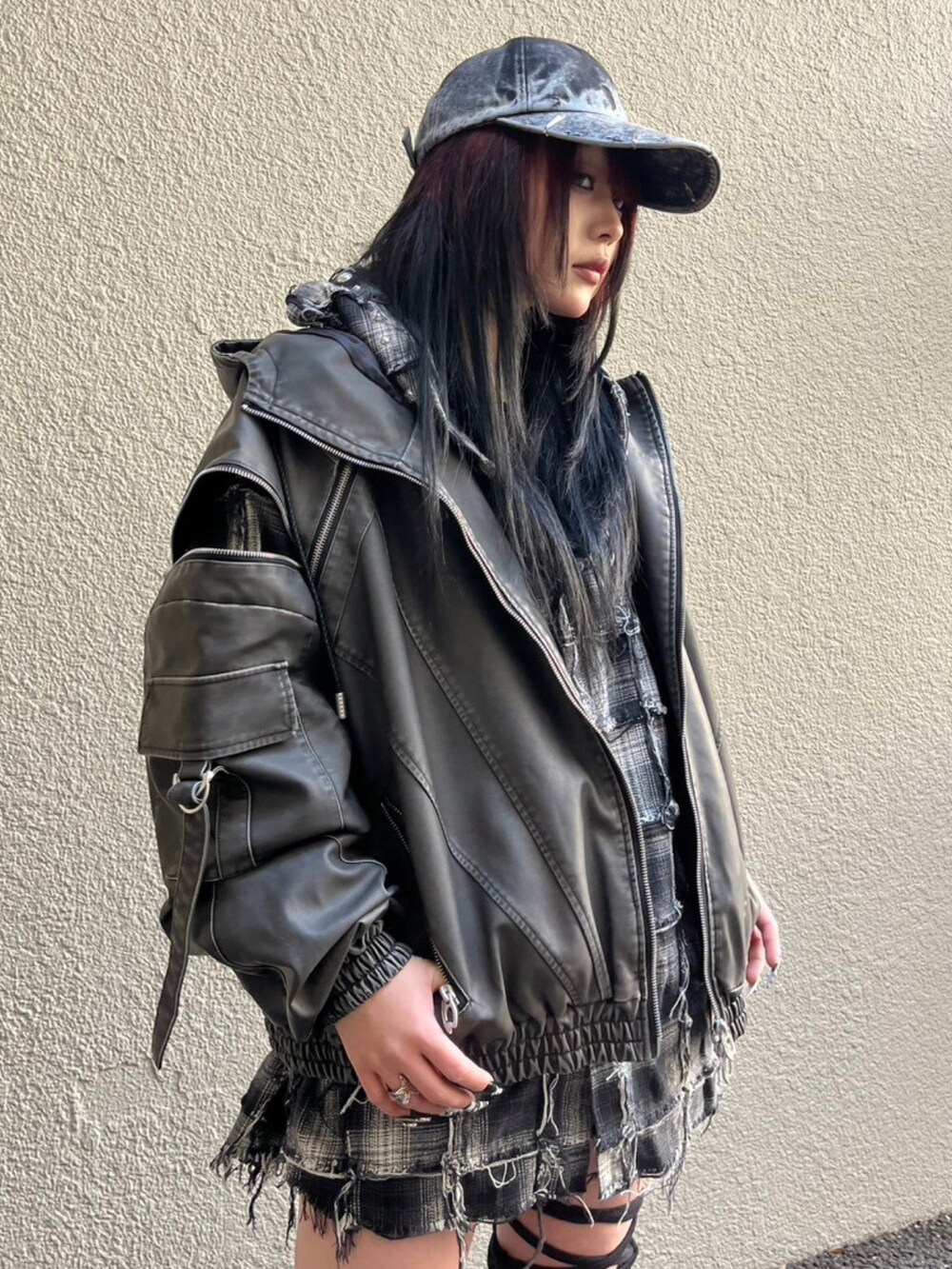 ブラック系のブルゾン、グレー系のキャップ、ブラック系のレッグウォーマーを着用したレディースの冬コーディネートの3枚目の写真