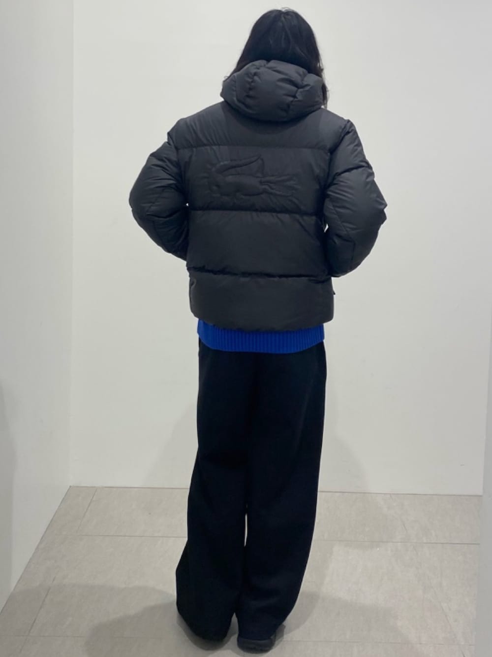 ブラック系のダウンジャケット/コート、ブルー系のニット/セーター、ブラック系のその他パンツを着用したメンズの夏コーディネートの3枚目の写真