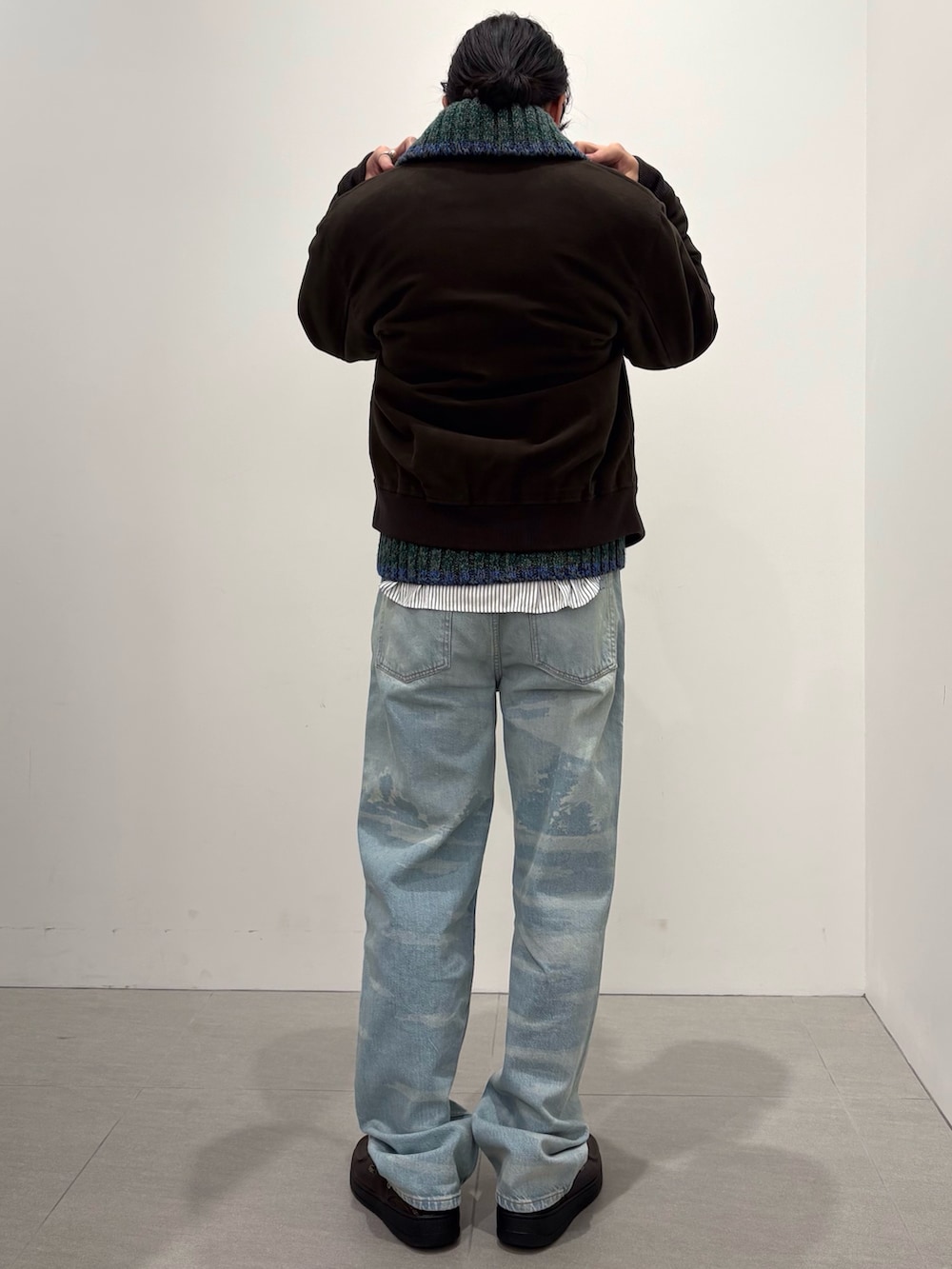 ブラウン系のブルゾン、ホワイト系のシャツ/ブラウス、グリーン系のニット/セーターを着用したメンズの冬コーディネートの3枚目の写真