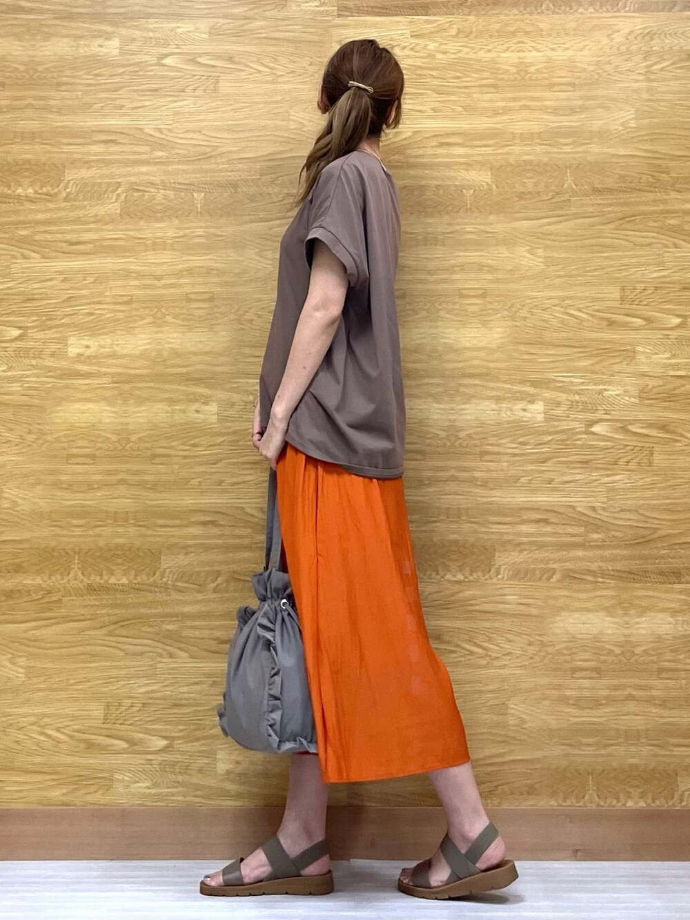 オレンジ系のその他パンツ、グレー系のトートバッグ、ベージュ系のサンダルを着用したレディースの夏コーディネートの2枚目の写真
