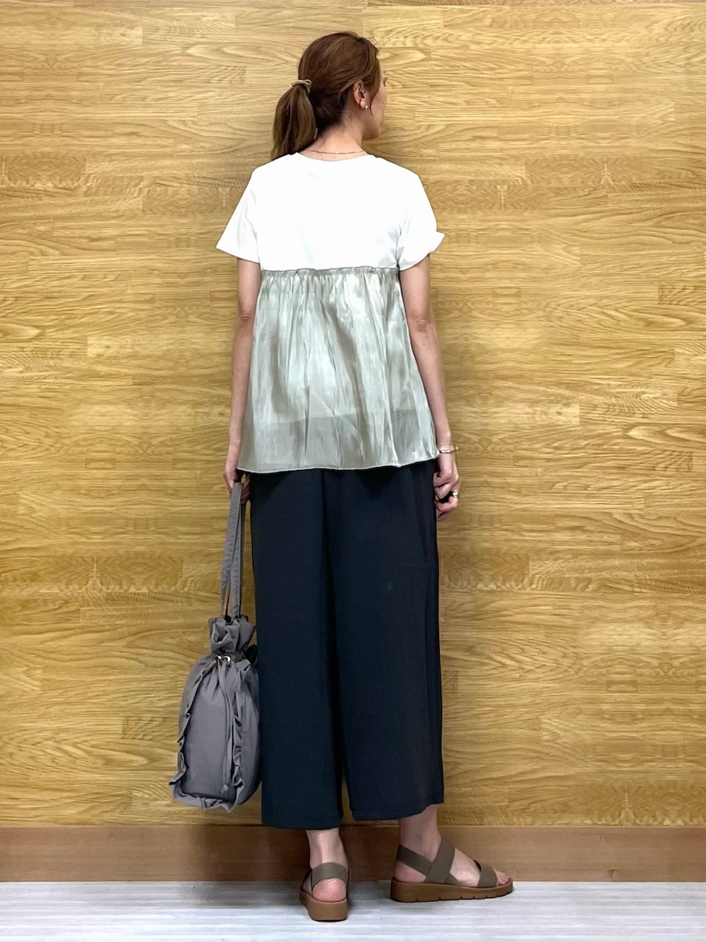 グリーン系のTシャツ/カットソー、グレー系のその他パンツ、グレー系のトートバッグを着用したレディースの夏コーディネートの3枚目の写真