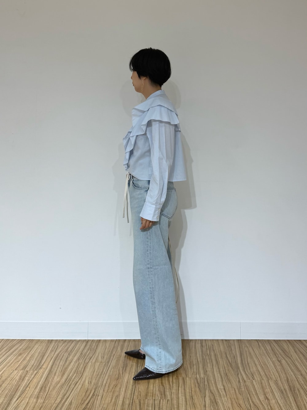 ブルー系のシャツ/ブラウス、ブラウン系のその他アウター、ブルー系のデニムパンツを着用したレディースの秋コーディネートの5枚目の写真