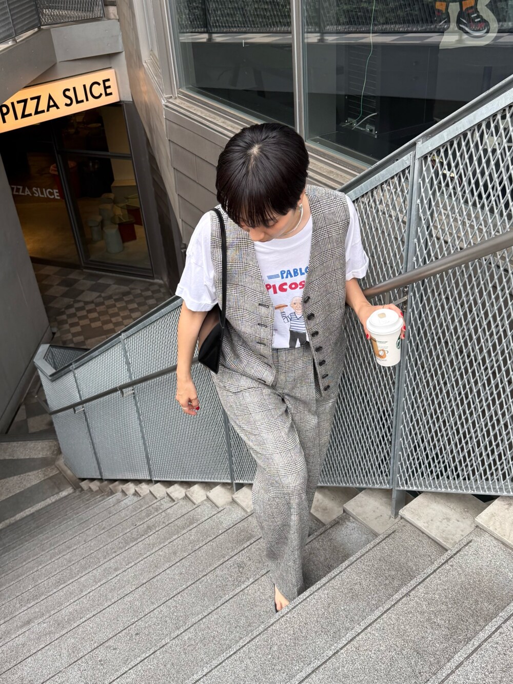 シルバー系のサンダル、ブラック系のショルダーバッグ、グレー系のベストを着用したレディースの夏コーディネートの3枚目の写真