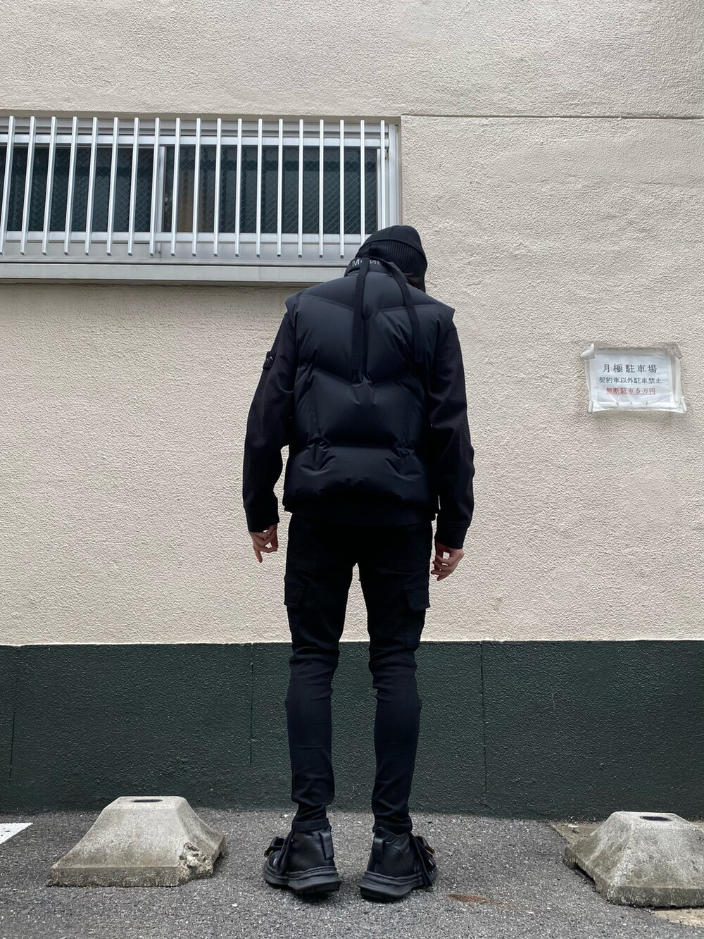 ブラック系のダウンベスト、ブラック系のカーゴパンツ、ブラック系のスウェットを着用したメンズの秋コーディネートの3枚目の写真