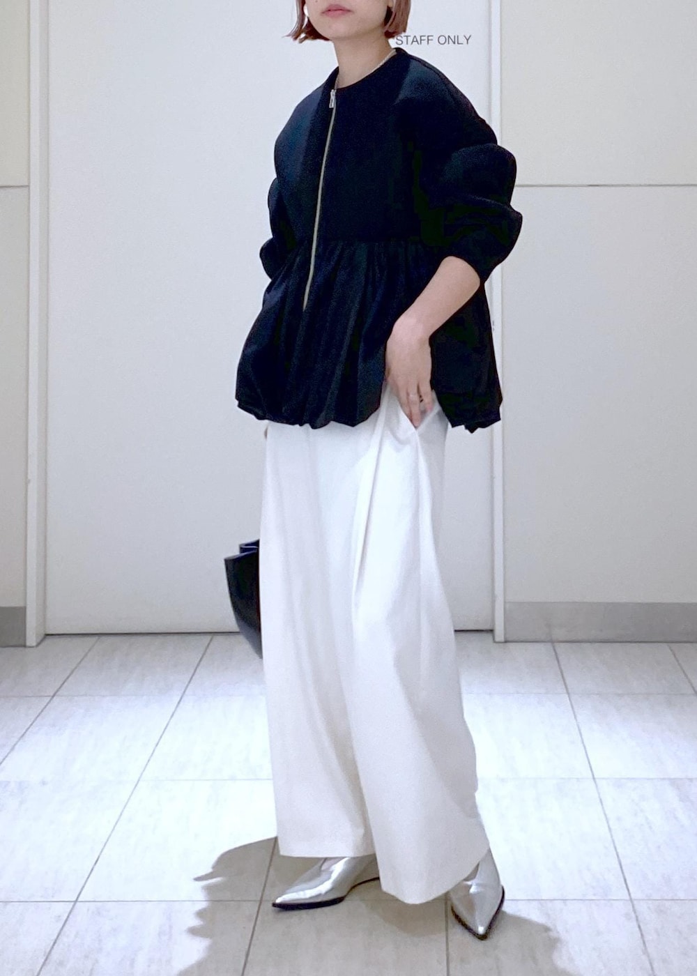 ホワイト系のその他パンツ、ブラック系のカーディガン/ボレロ、シルバー系のパンプスを着用したレディースの冬コーディネートの3枚目の写真