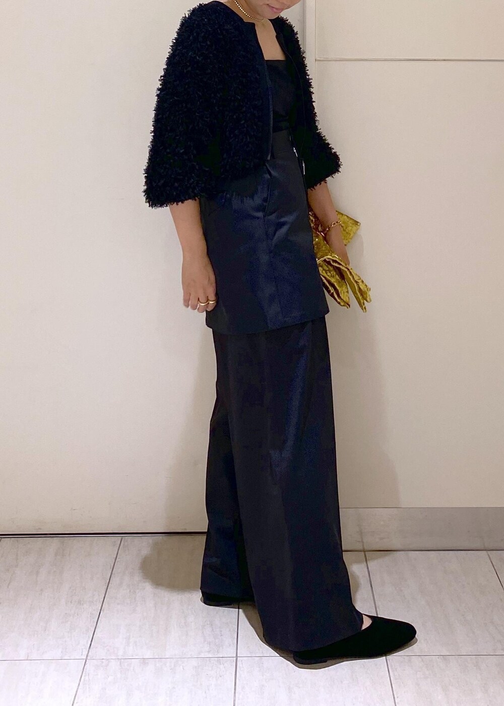 ブラック系のパンプス、ブラック系のスラックス、ブラック系のスカートを着用したレディースの秋コーディネートの4枚目の写真