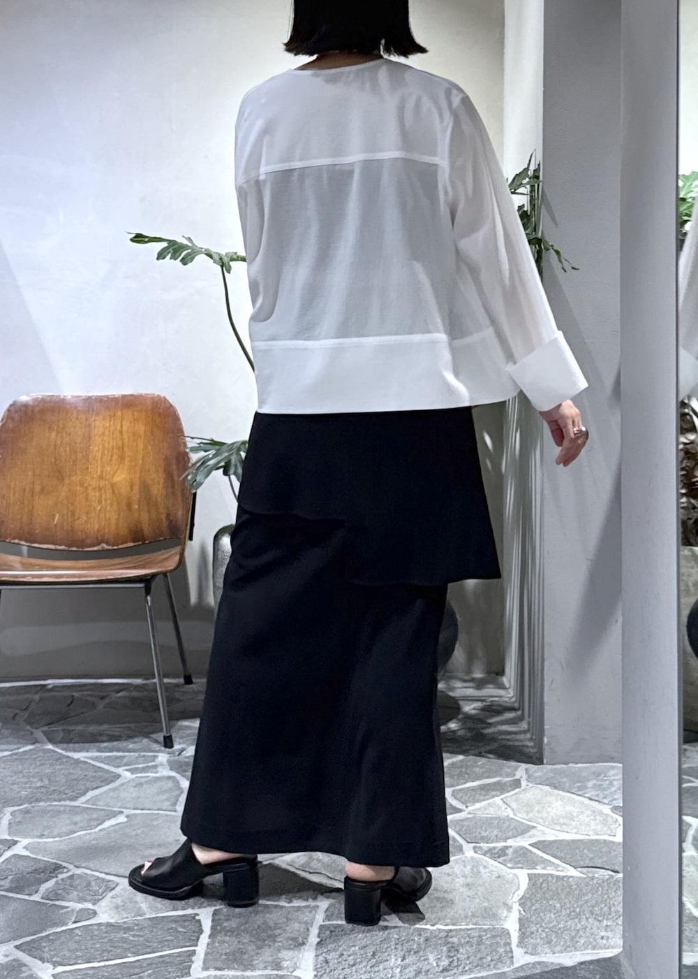ブラック系のサンダル、ブラック系のクラッチバッグ、ブラック系のスカートを着用したレディースの夏コーディネートの4枚目の写真