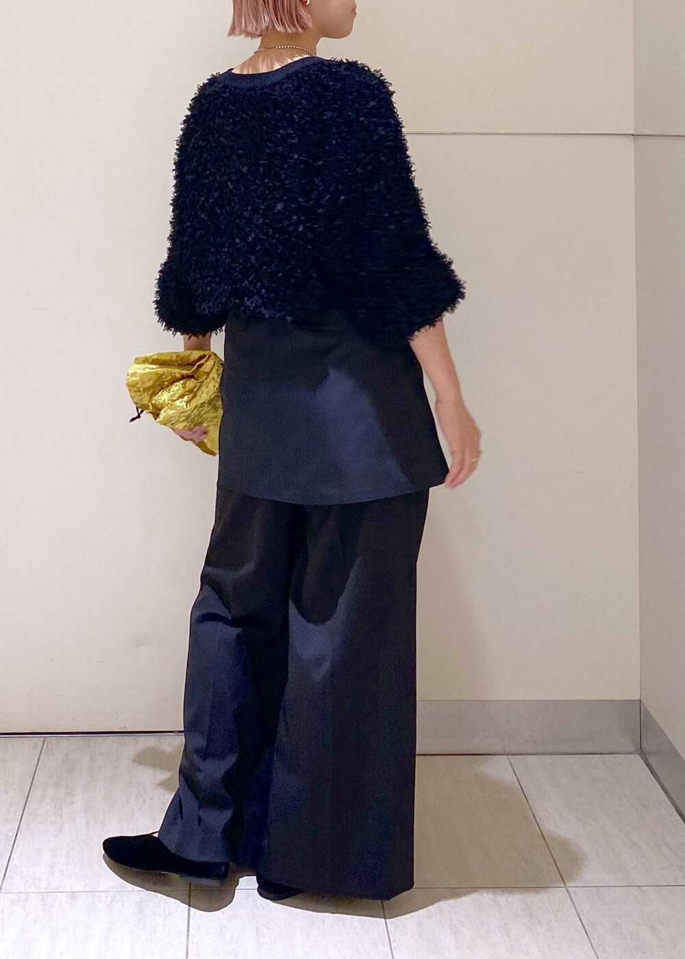 ブラック系のパンプス、ブラック系のスラックス、ブラック系のスカートを着用したレディースの秋コーディネートの3枚目の写真