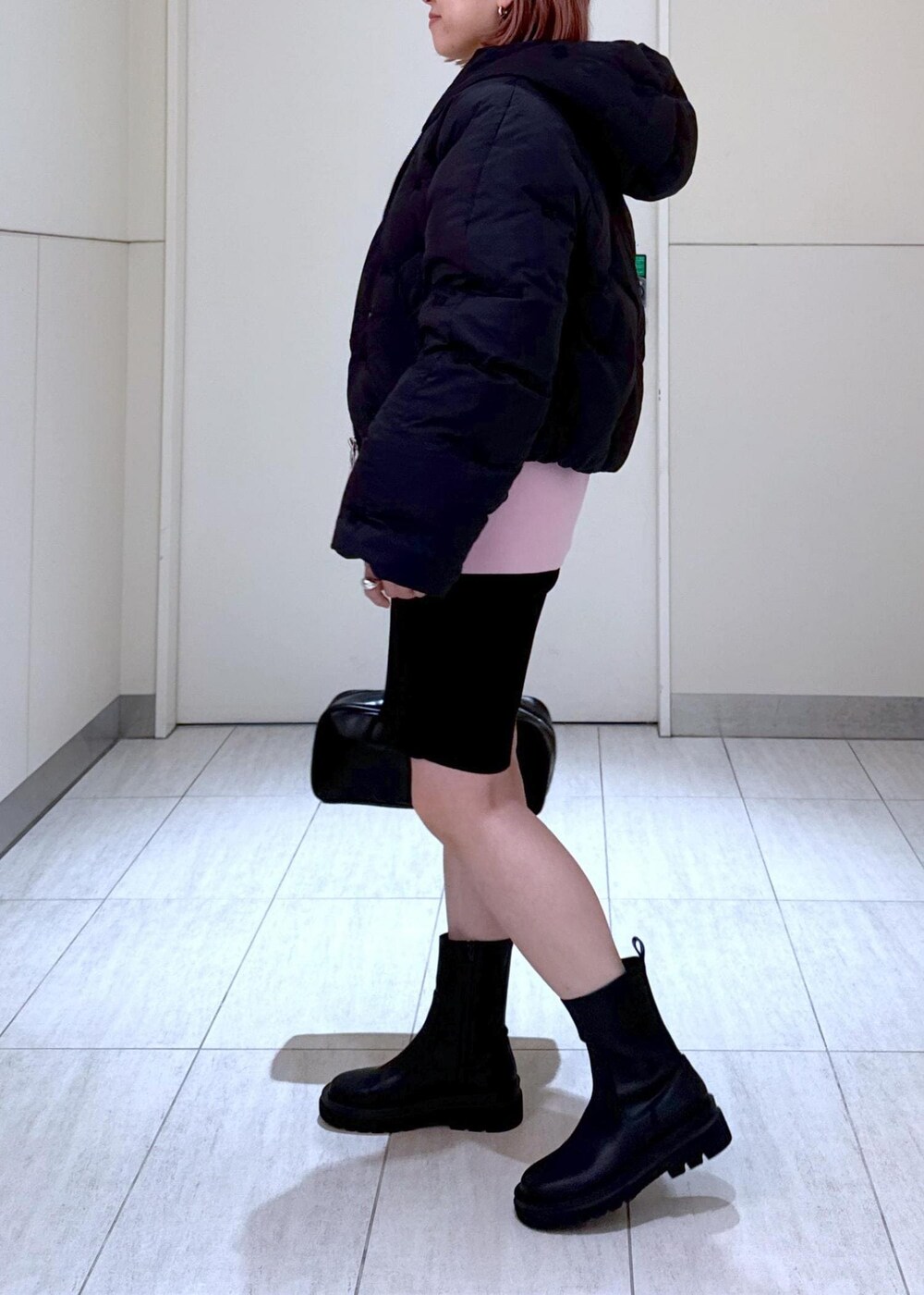 ブラック系のブーツ、ピンク系のその他トップス、ブラック系のボストンバッグを着用したレディースの秋コーディネートの5枚目の写真