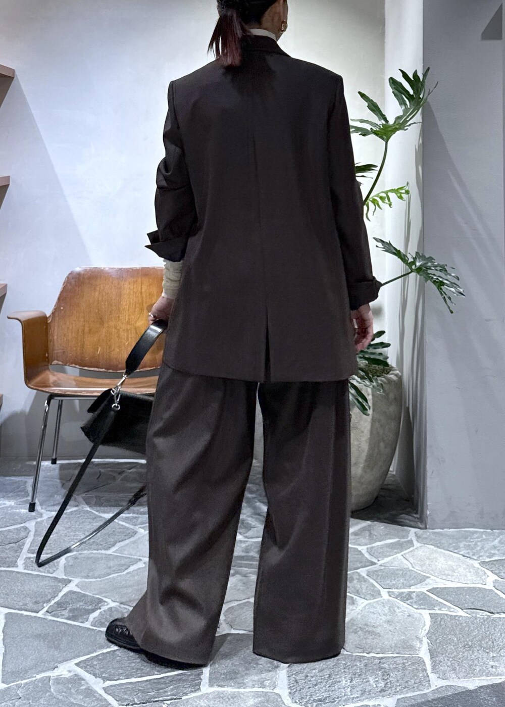ブラック系のショルダーバッグ、ホワイト系のTシャツ/カットソー、ブラウン系のテーラードジャケットを着用したレディースの秋コーディネートの5枚目の写真