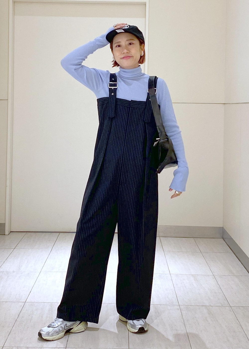 ブルー系のニット/セーター、グレー系のブルゾン、ブラック系のショルダーバッグを着用したレディースの冬コーディネートの4枚目の写真