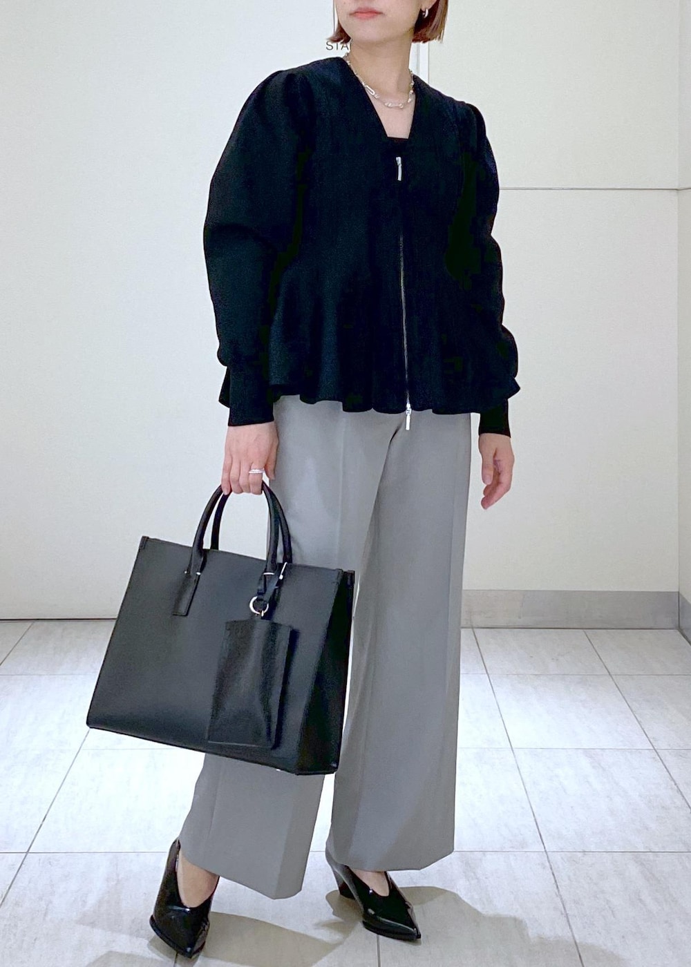 ブラック系のパンプス、ブラック系のキャミソール、ブラック系のトートバッグを着用したレディースの春コーディネートの10枚目の写真