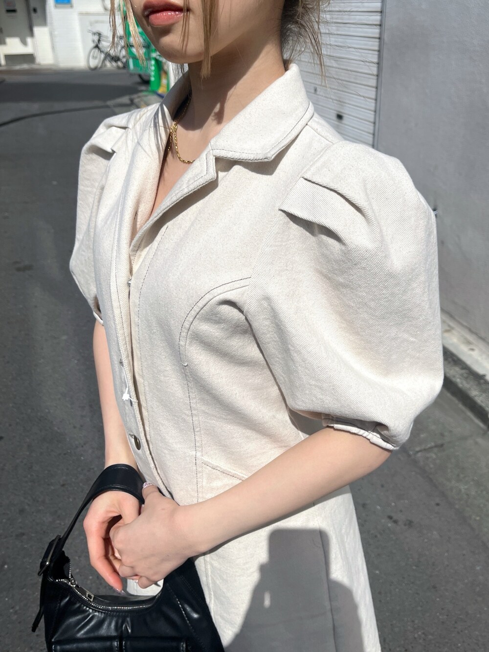 ブラック系のショルダーバッグ、ホワイト系のワンピースを着用したレディースの春コーディネートの9枚目の写真