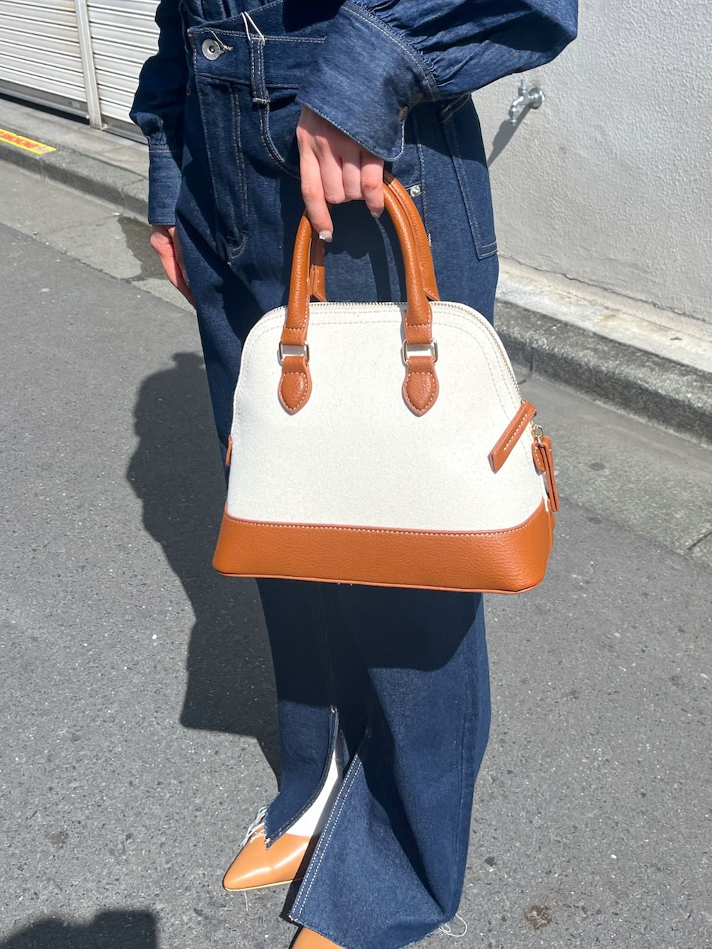 ブルー系のシャツ/ブラウス、ブルー系のデニムパンツ、ブラウン系のショルダーバッグを着用したレディースの春コーディネートの10枚目の写真