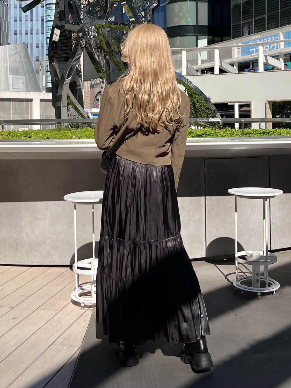 ブラック系のショルダーバッグ、ホワイト系のTシャツ/カットソー、ブラウン系のテーラードジャケットを着用したレディースの秋コーディネートの4枚目の写真