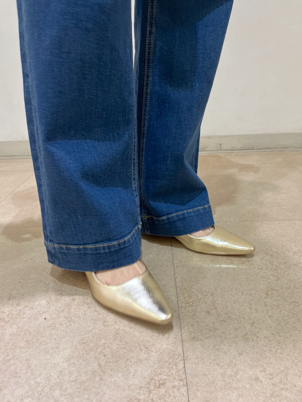 ブラウン系のシャツ/ブラウス、ブルー系のデニムパンツ、ゴールド系のパンプスを着用したレディースの春コーディネートの9枚目の写真