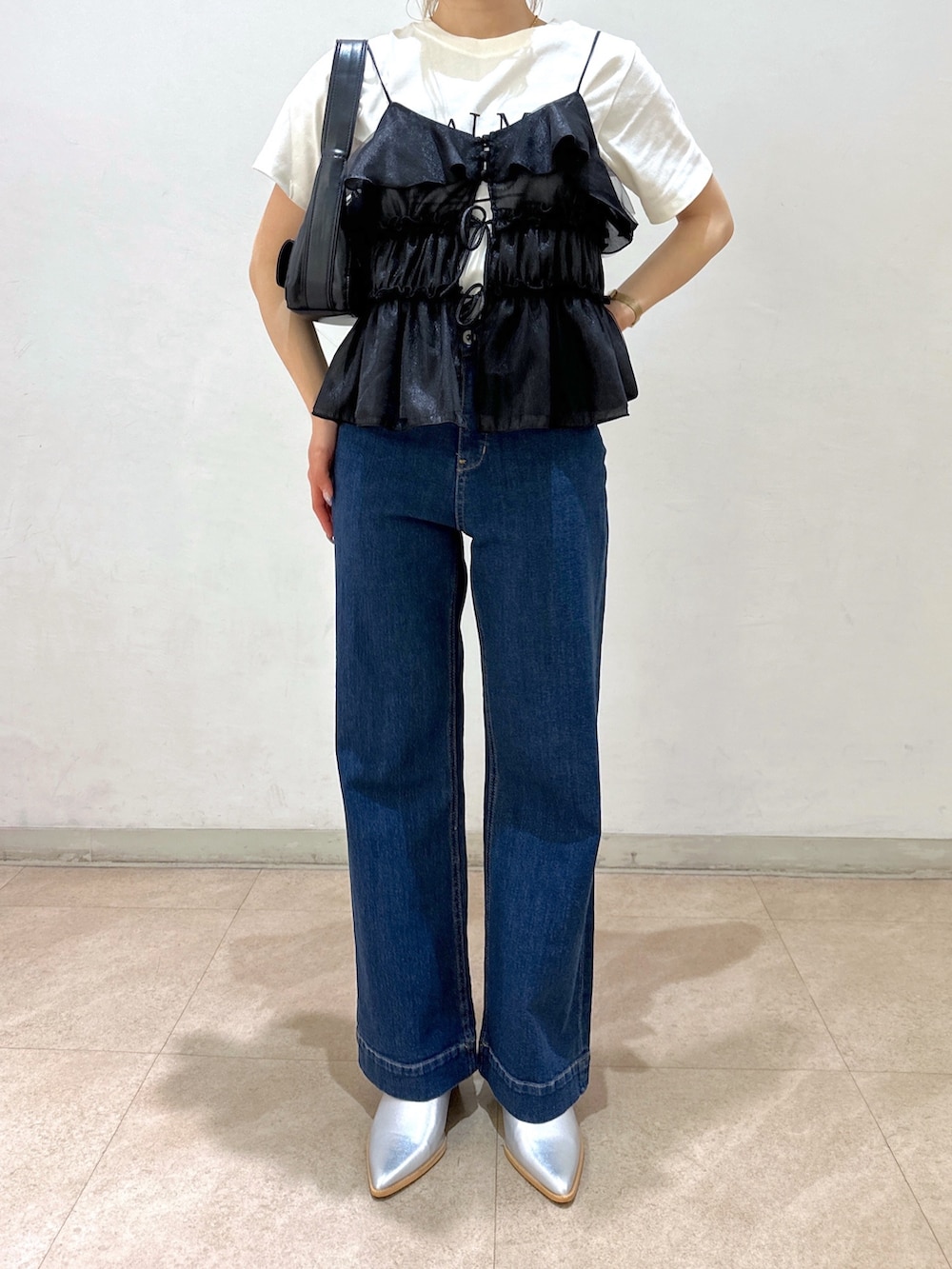 ブラック系のショルダーバッグ、ブラック系のシャツ/ブラウス、ホワイト系のTシャツ/カットソーを着用したレディースの春コーディネートの8枚目の写真