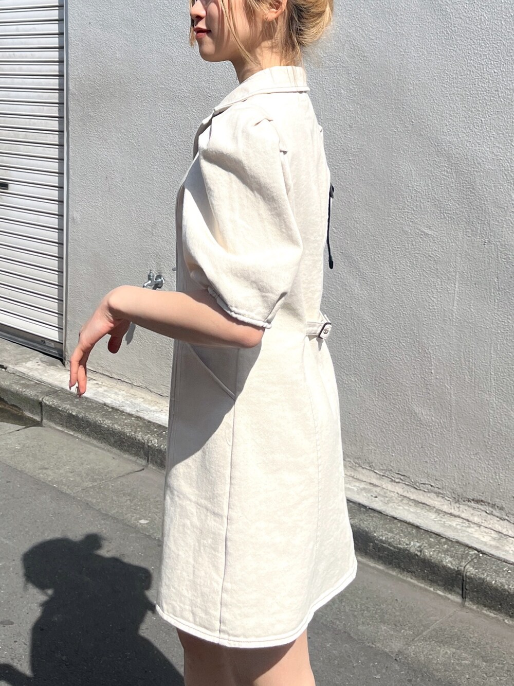 ブラック系のショルダーバッグ、ホワイト系のワンピースを着用したレディースの春コーディネートの7枚目の写真