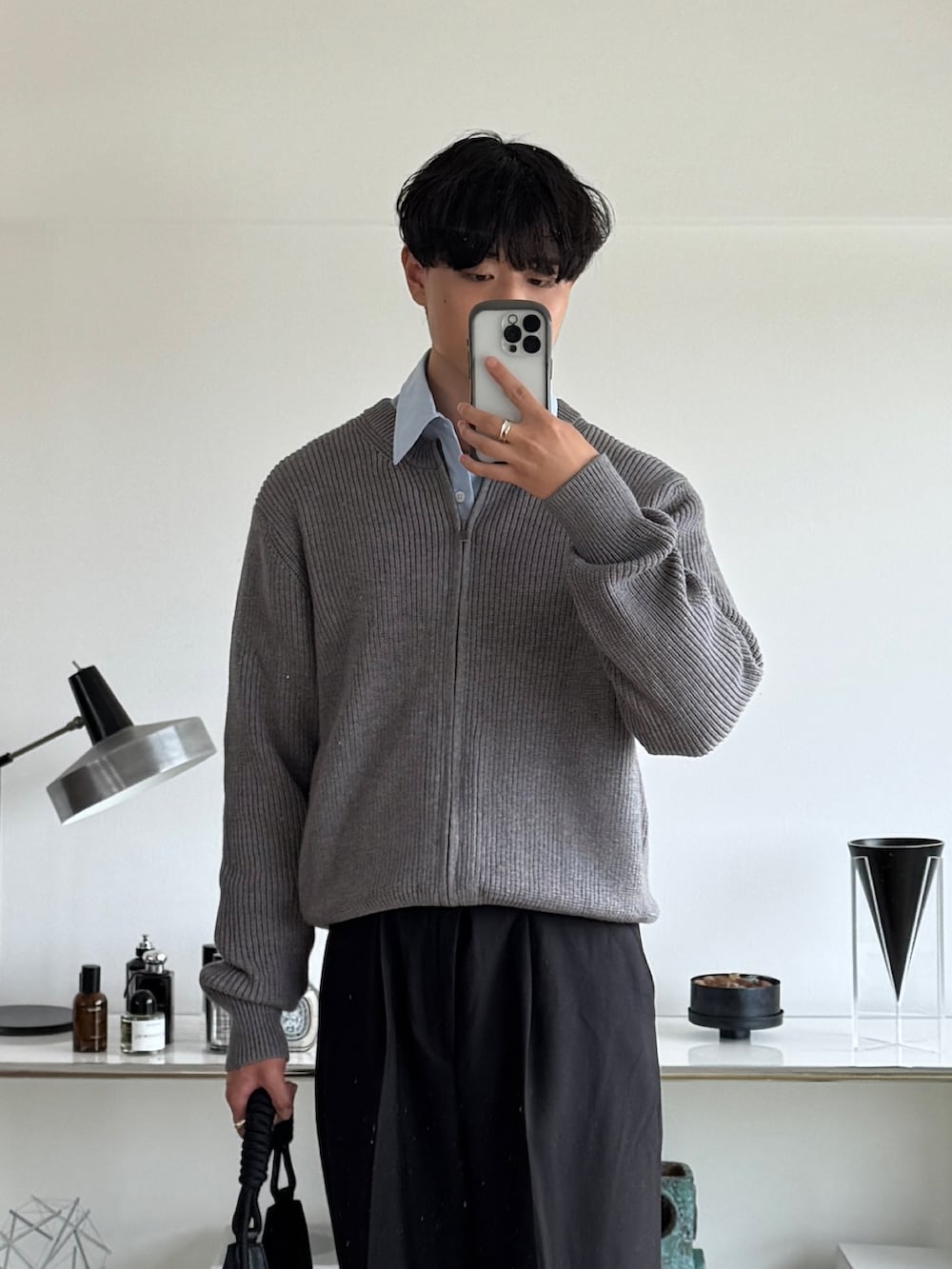 ブラック系のスラックス、ブルー系のシャツ/ブラウス、ブラック系のトートバッグを着用したメンズの秋コーディネートの3枚目の写真