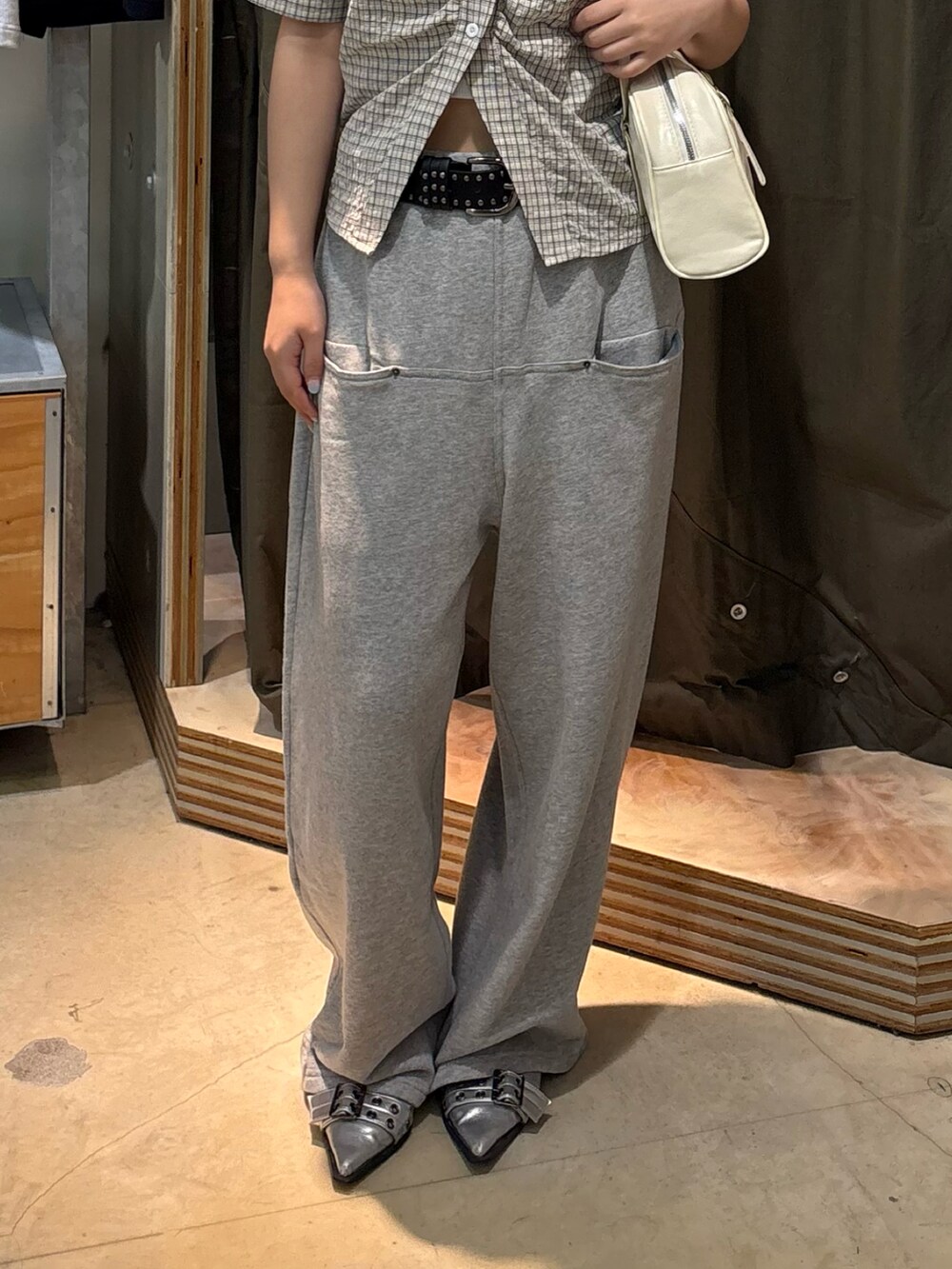 ホワイト系のシャツ/ブラウス、グレー系のスウェットパンツ、ホワイト系のショルダーバッグを着用したレディースの夏コーディネートの3枚目の写真