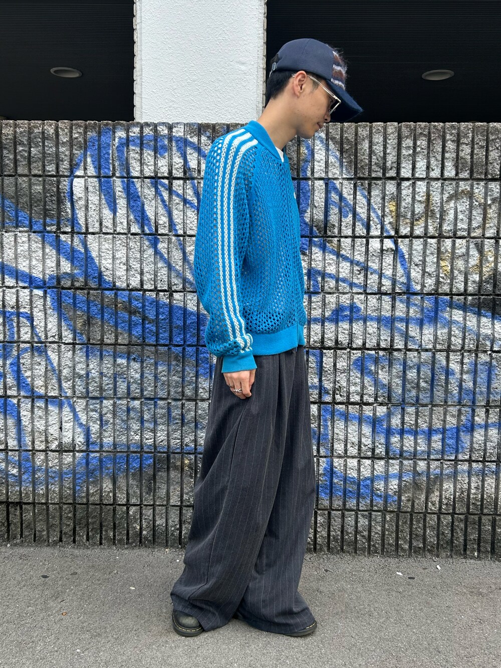 ブルー系のキャップを着用したメンズの秋コーディネートの4枚目の写真