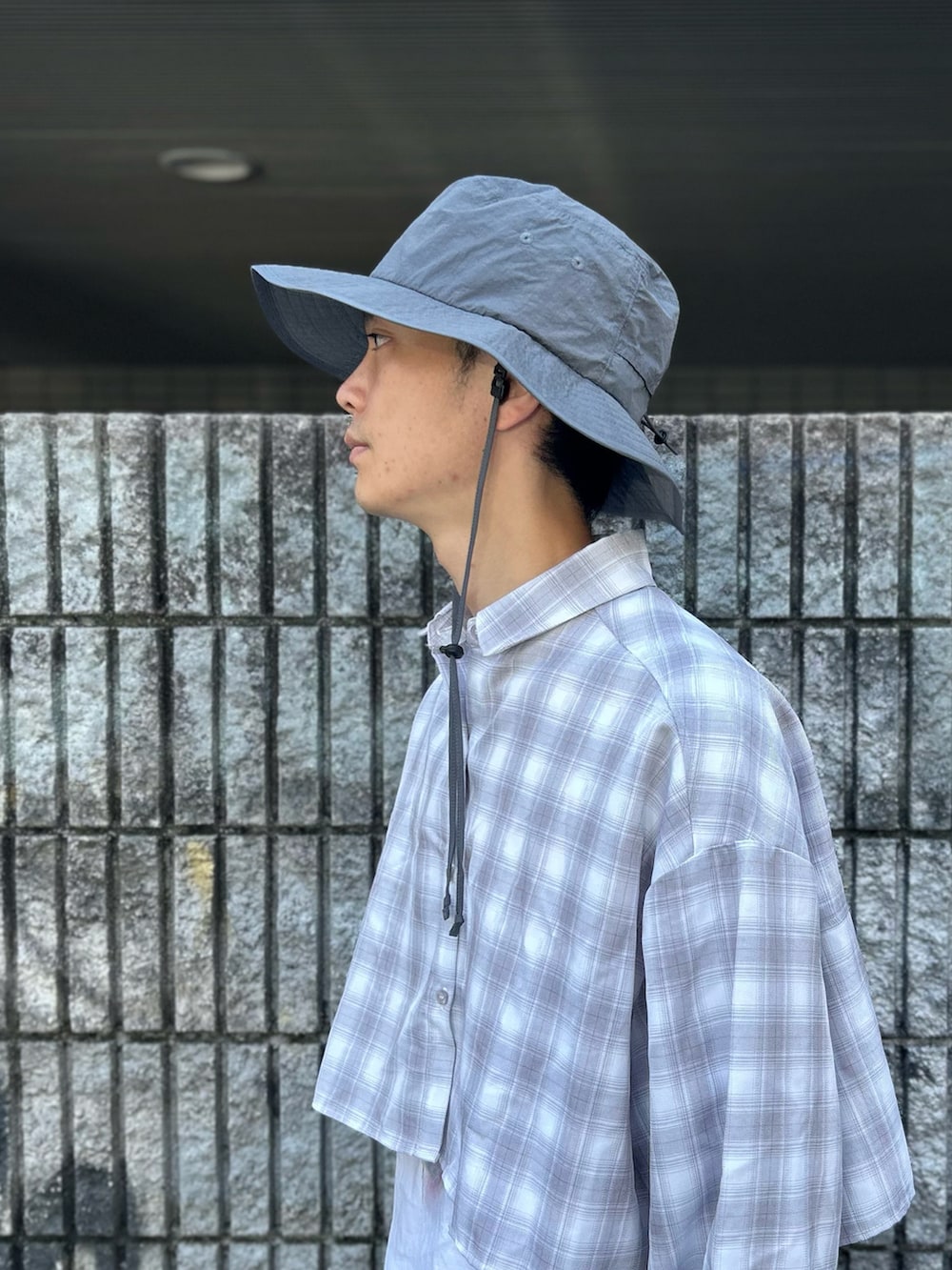 グレー系のハットを着用したメンズの夏コーディネートの5枚目の写真