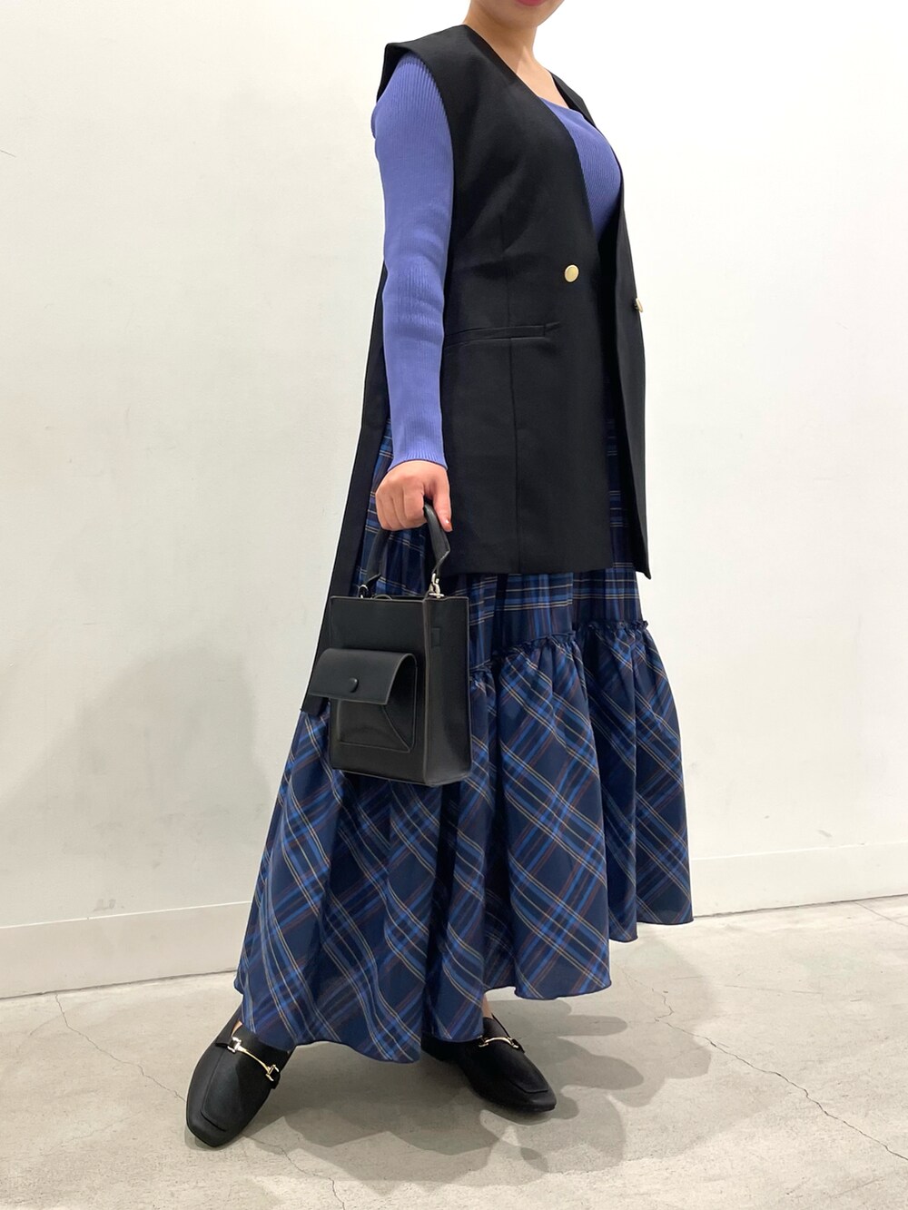 パープル系のニット/セーター、ブラック系のローファー、ブラック系のベストを着用したレディースの夏コーディネートの2枚目の写真