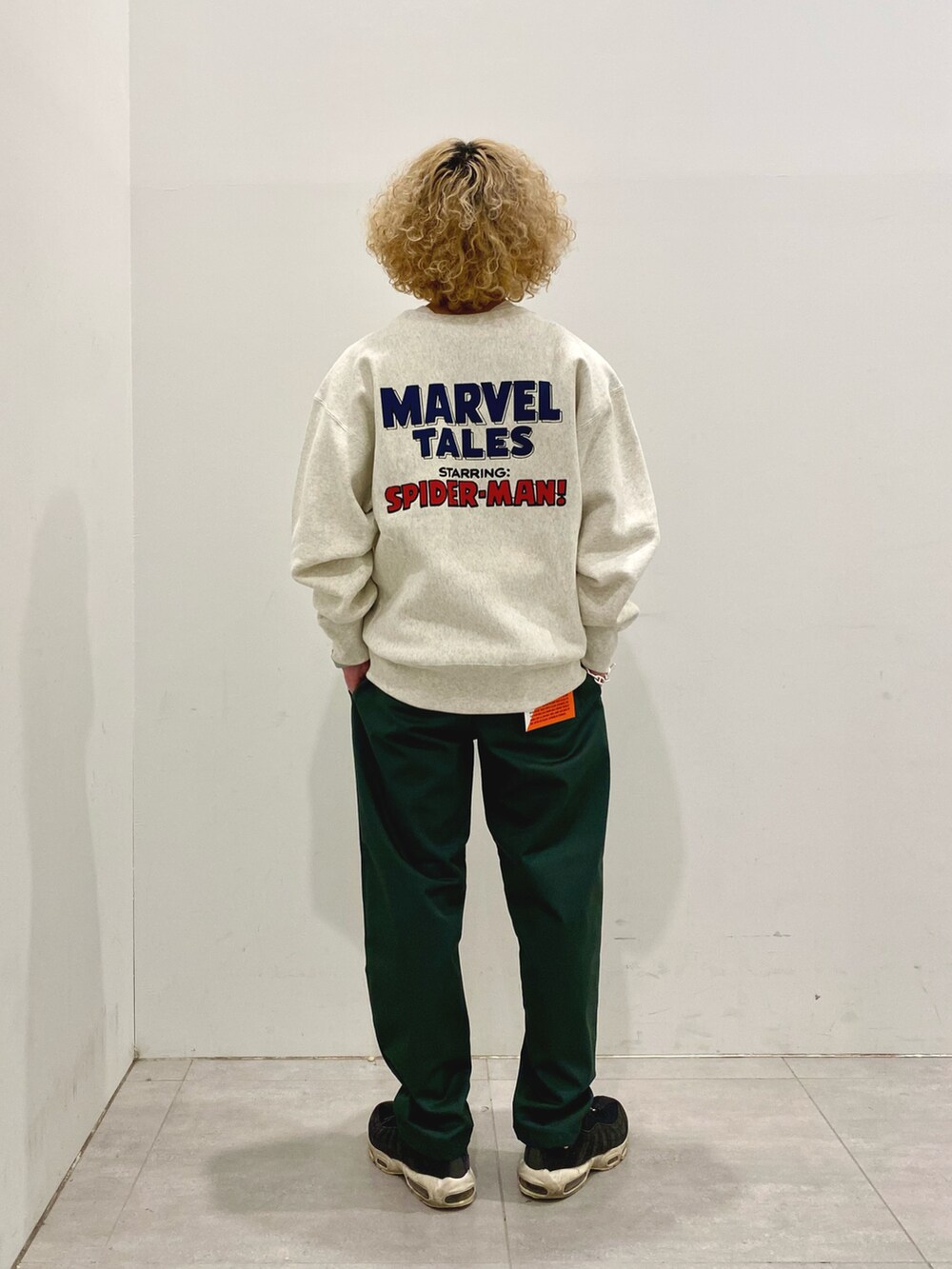 ホワイト系のスウェット、グリーン系のチノパンツを着用したメンズの冬コーディネートの2枚目の写真