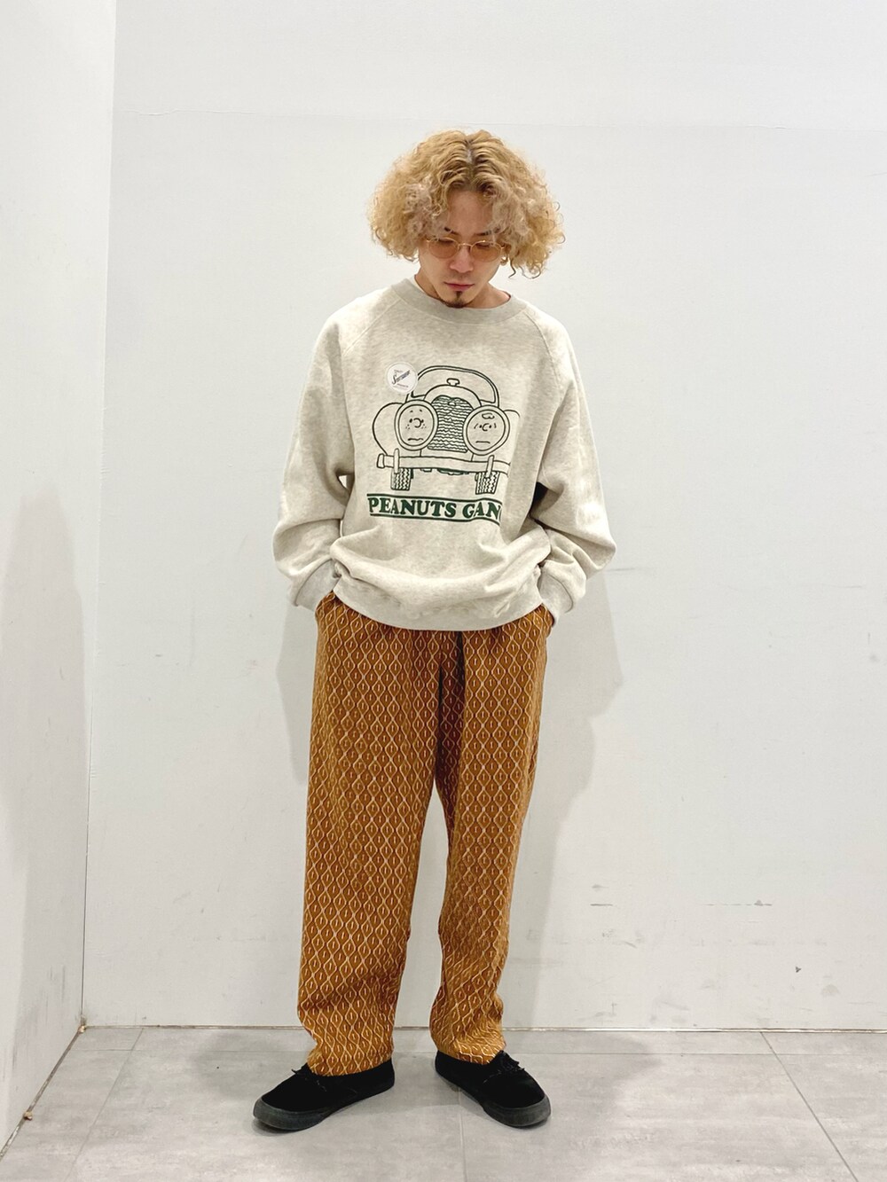 ブラック系のダウンジャケット/コート、ホワイト系のスウェット、イエロー系のスラックスを着用したメンズの冬コーディネートの2枚目の写真