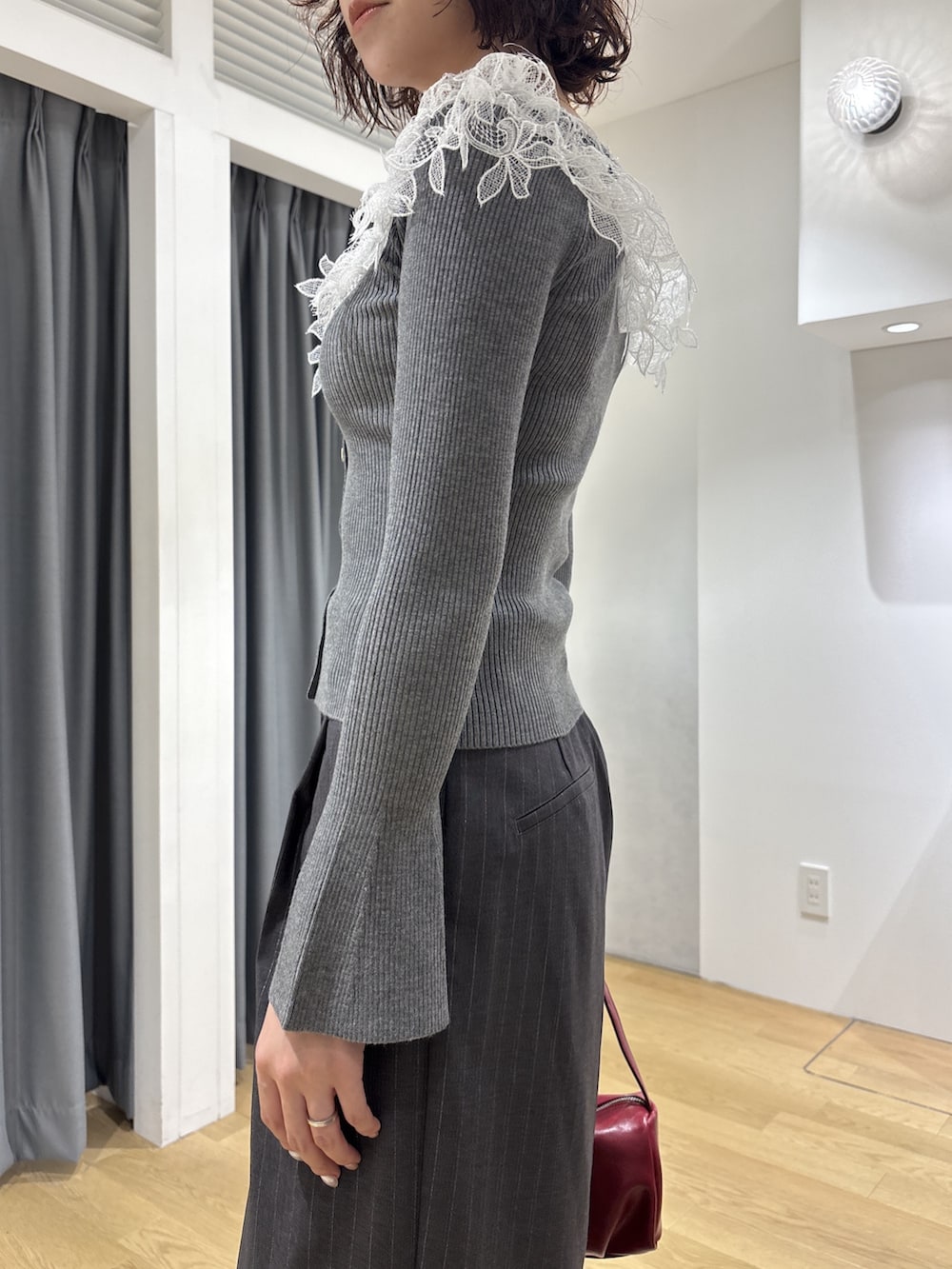グレー系のその他パンツ、レッド系のハンドバッグ、ブラウン系のパンプスを着用したレディースの秋コーディネートの6枚目の写真
