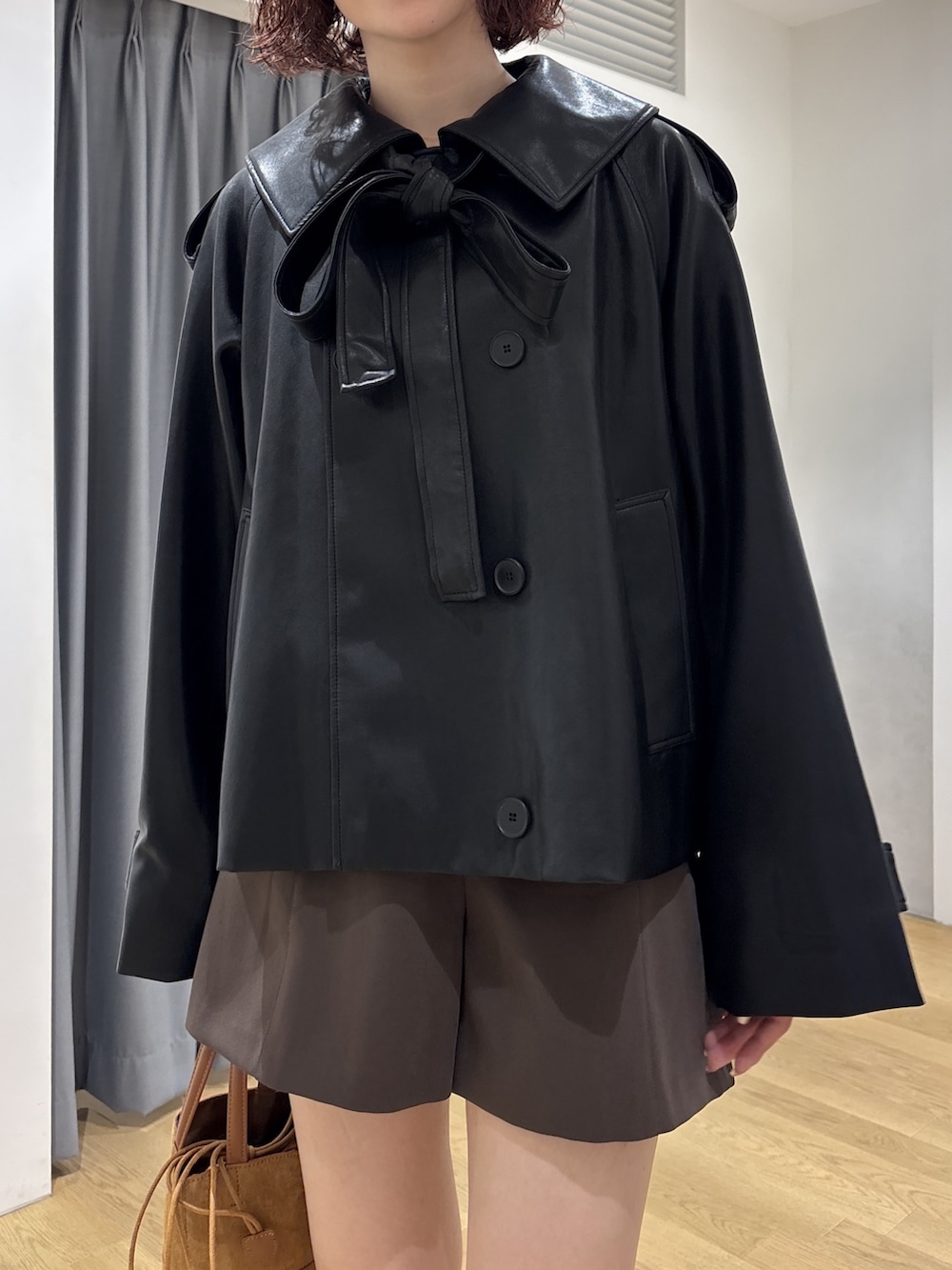 ブラウン系のその他パンツ、ブラック系のその他アウター、ブラック系のTシャツ/カットソーを着用したレディースの秋コーディネートの6枚目の写真