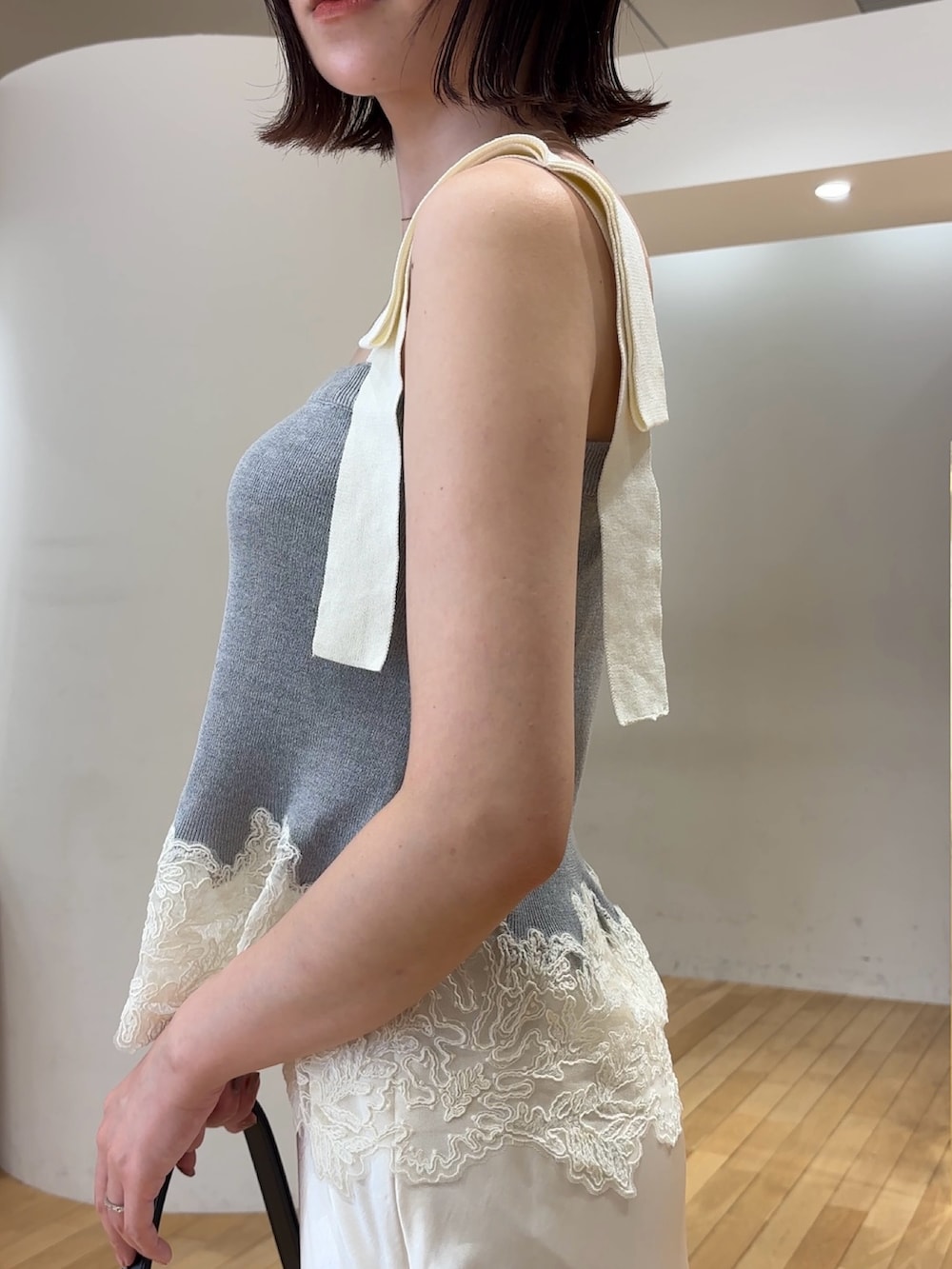 ホワイト系のスカート、グレー系のキャミソール、シルバー系のパンプスを着用したレディースの夏コーディネートの6枚目の写真