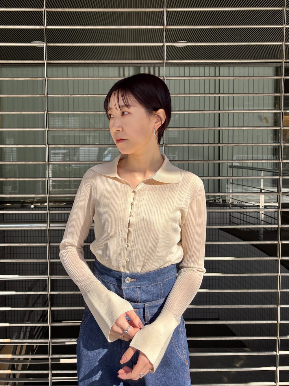 ホワイト系のTシャツ/カットソー、ブラック系のサンダル、ブルー系のデニムパンツを着用したレディースの春コーディネートの4枚目の写真