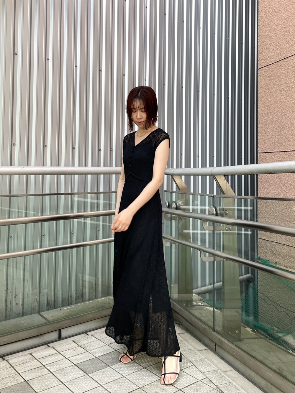 ブラック系のサンダル、ブラック系のワンピースを着用したレディースの夏コーディネートの2枚目の写真