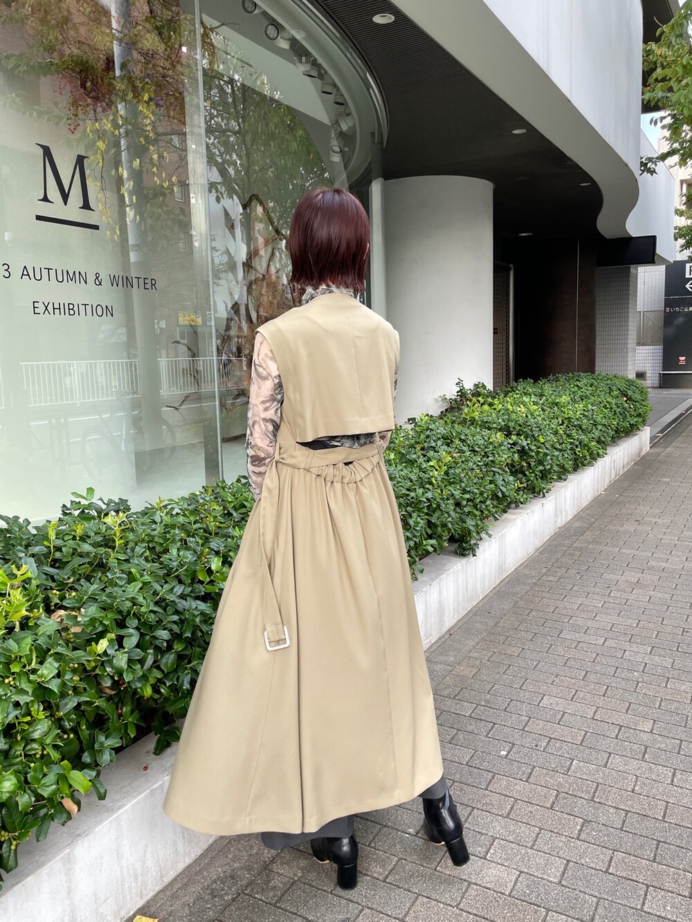 ブラック系のブーツ、グレー系のその他パンツ、グリーン系のトレンチコートを着用したレディースの冬コーディネートの4枚目の写真