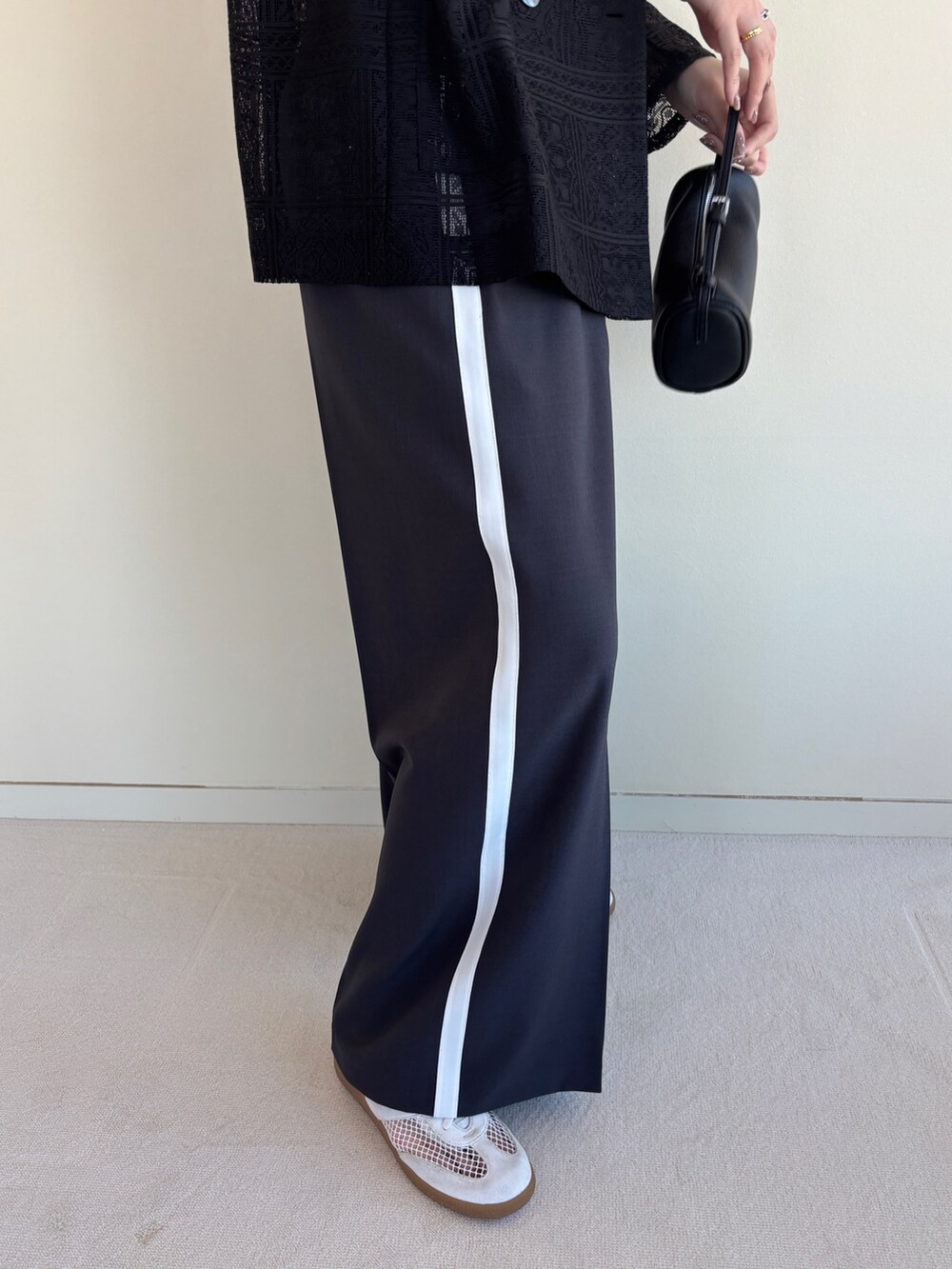 グレー系のその他パンツ、ブラック系のテーラードジャケット、ブラック系のチューブトップを着用したレディースの春コーディネートの6枚目の写真