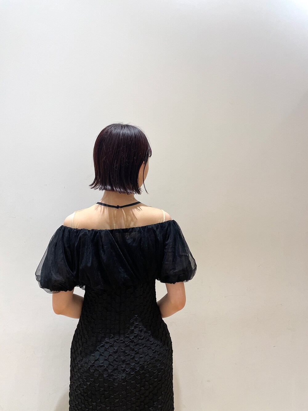 ブラック系のドレス、シルバー系のハンドバッグ、シルバー系のパンプスを着用したレディースの秋コーディネートの7枚目の写真