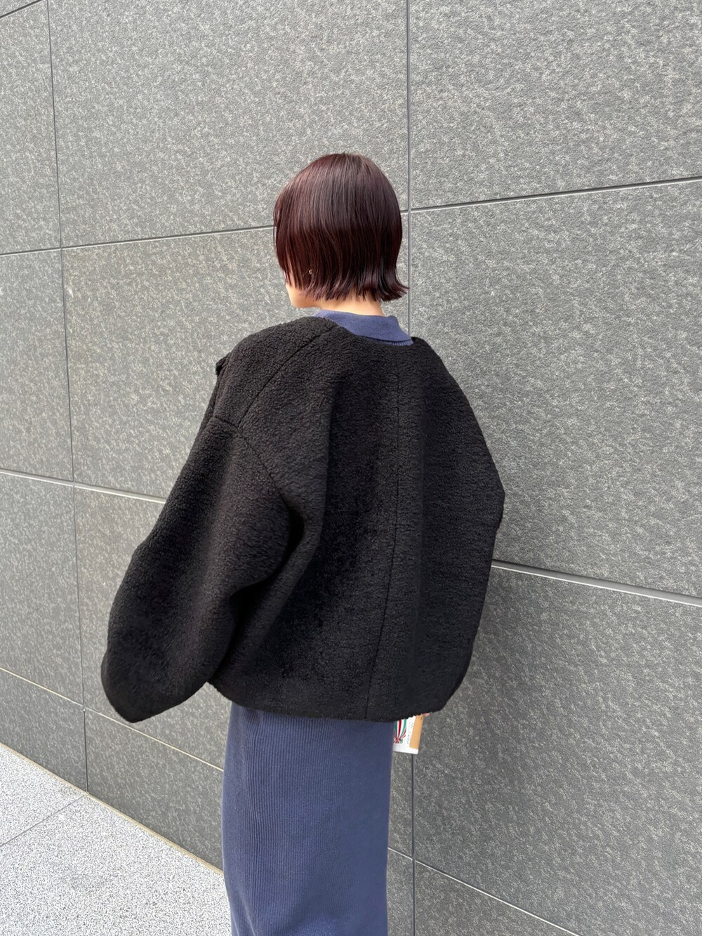 ブルー系のワンピース、ブラック系のブルゾンを着用したレディースの秋コーディネートの6枚目の写真