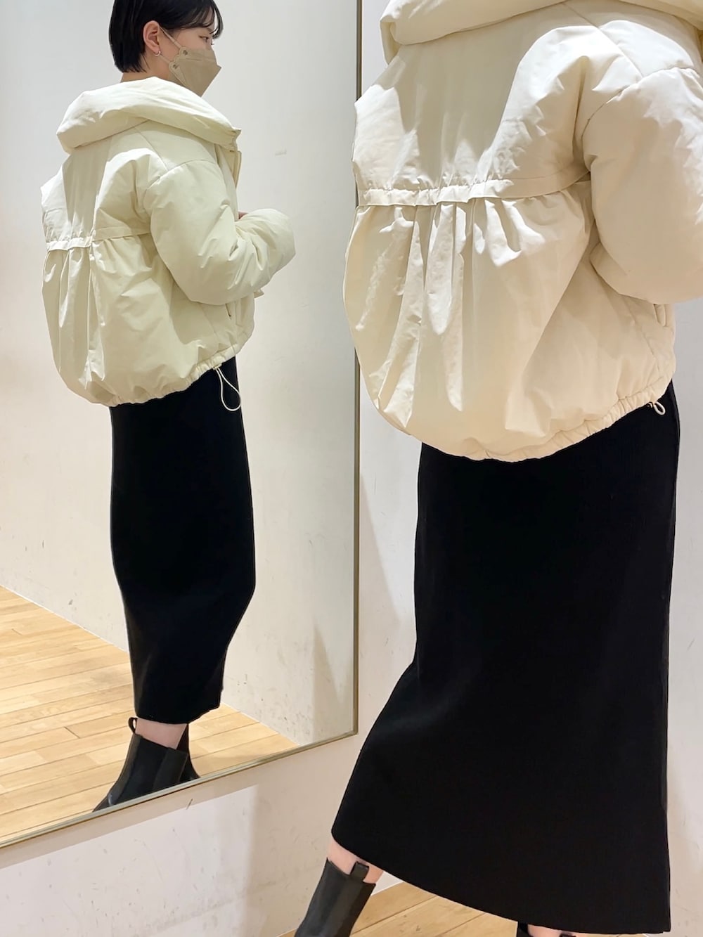 ホワイト系のダウンジャケット/コート、ブラック系のワンピース、ブラック系のブーツを着用したレディースの冬コーディネートの2枚目の写真